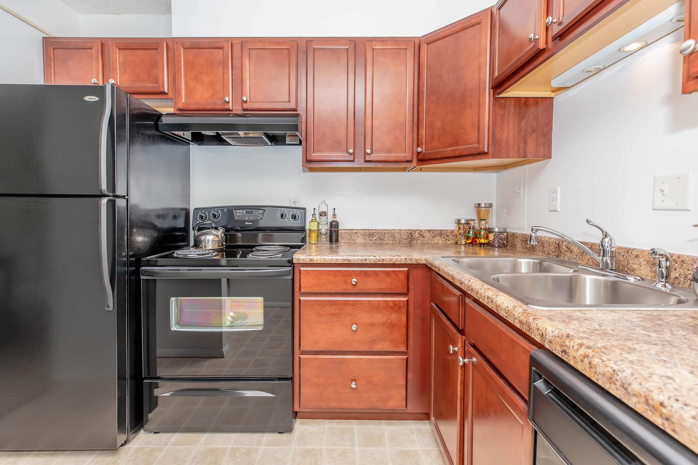 a kitchen with stainless steel appliances and wooden cabinets