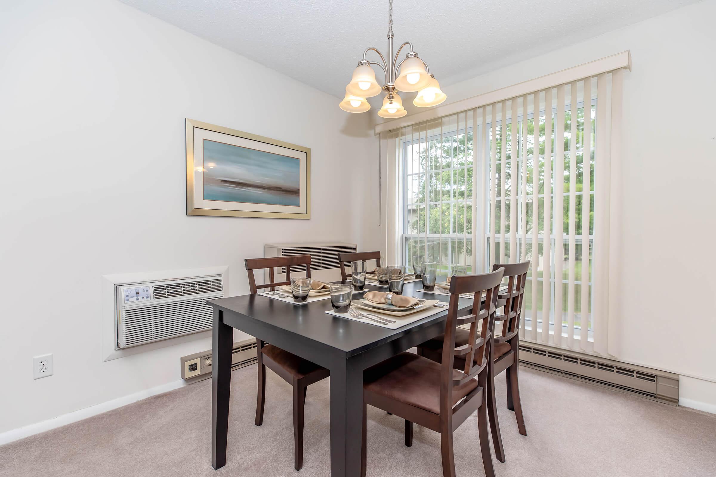 a dining room table in front of a window