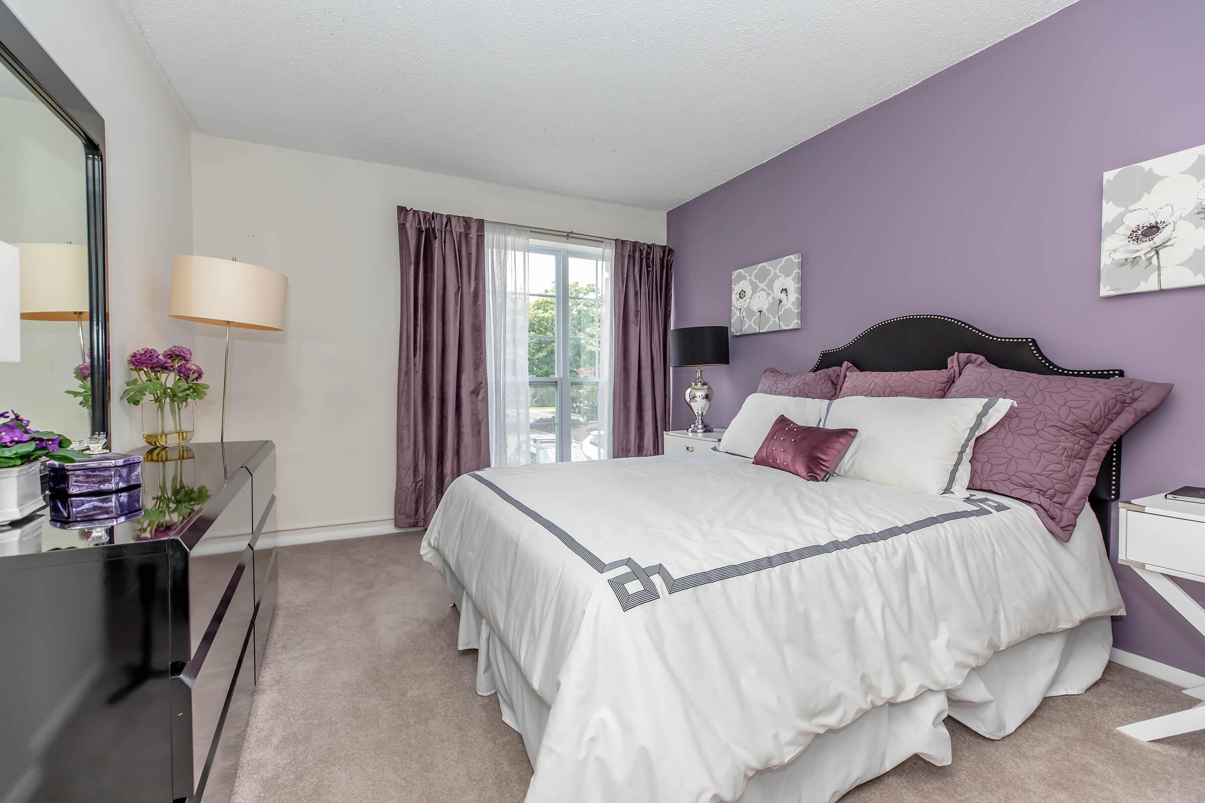 a bedroom with a large bed in a hotel room