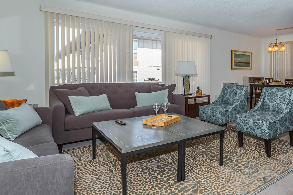 a living room filled with furniture and a large window