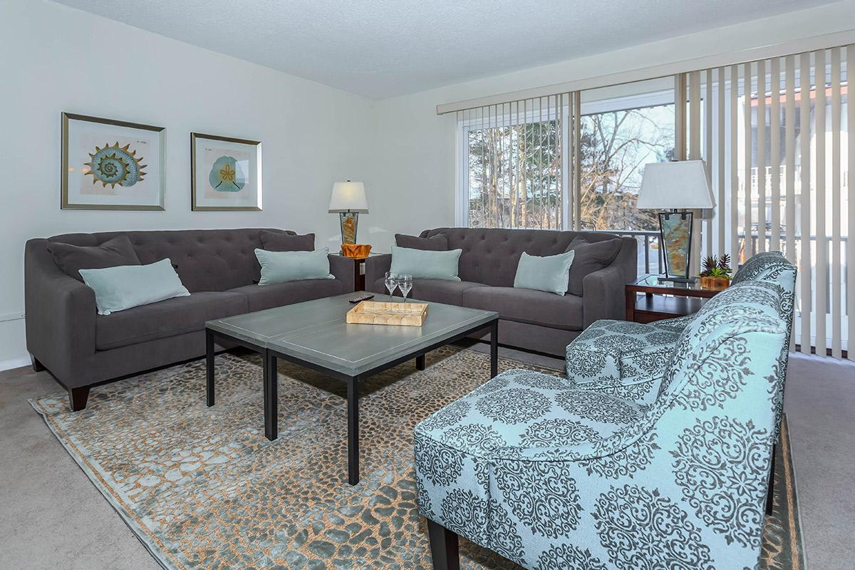 a living room filled with furniture and a large window