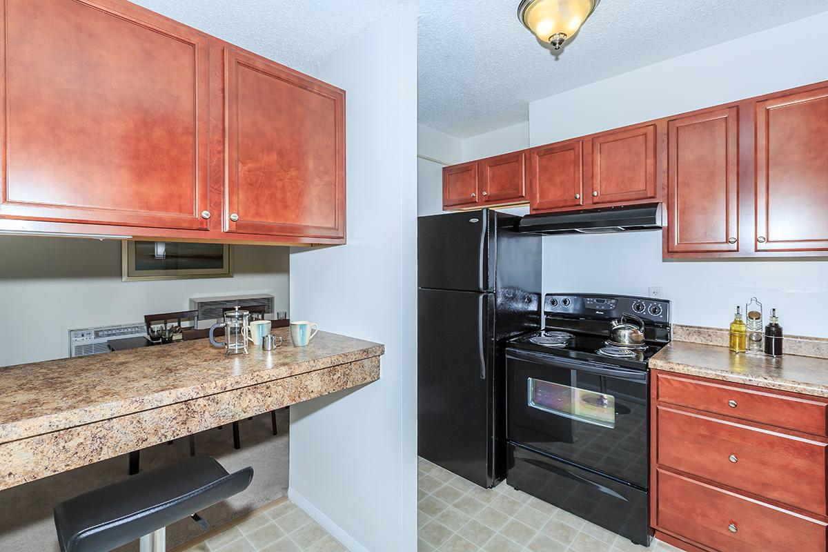 a modern kitchen with stainless steel appliances and wooden cabinets