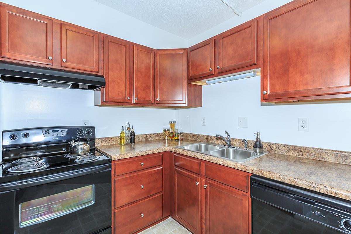 a kitchen with stainless steel appliances and wooden cabinets