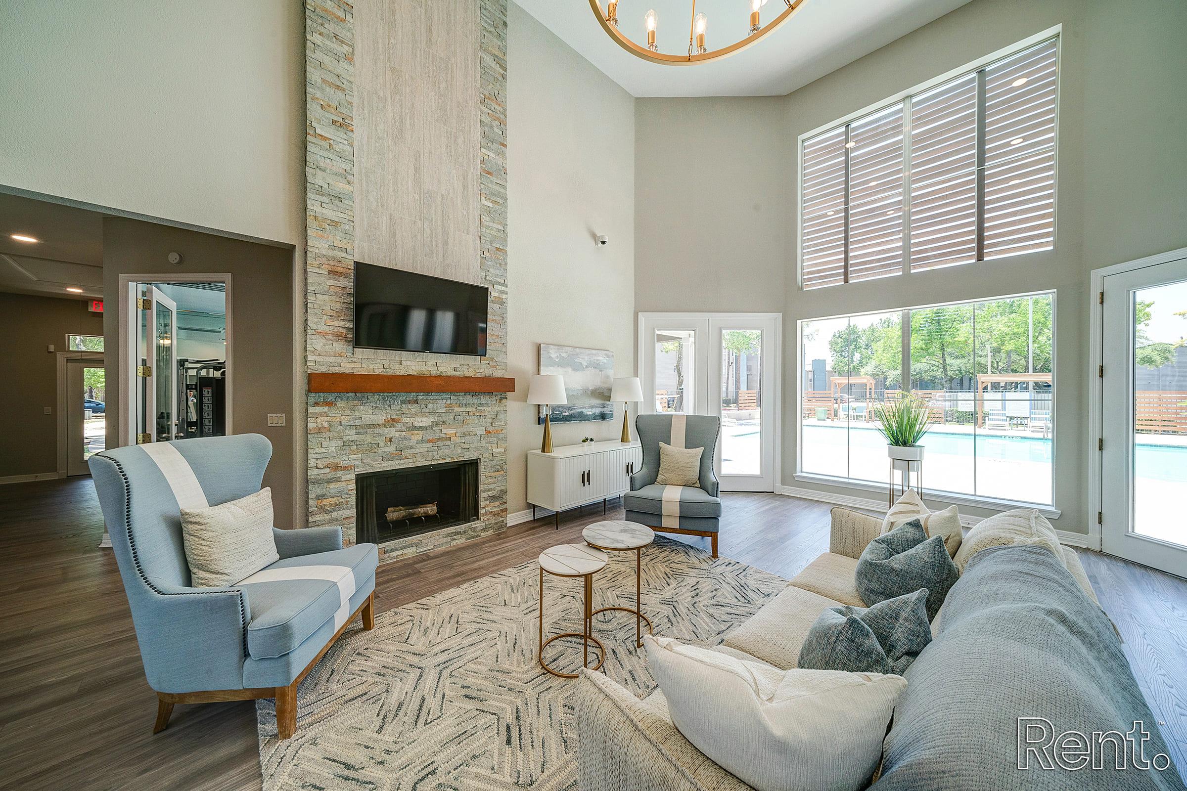 a living room filled with furniture and a large window