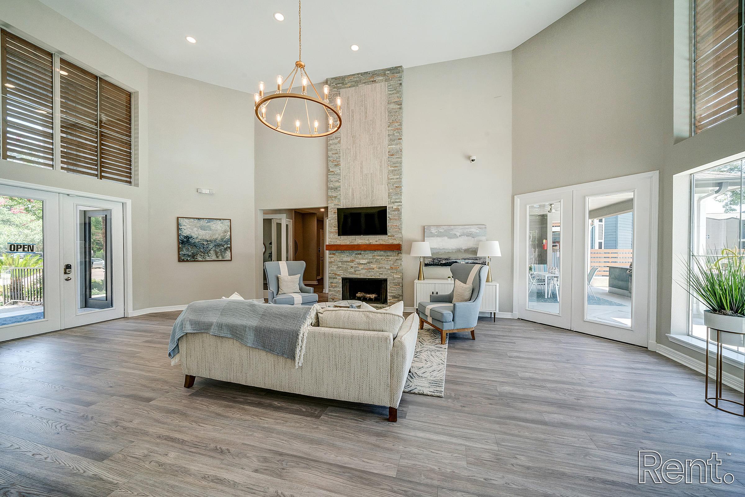 a living room filled with furniture and a large window