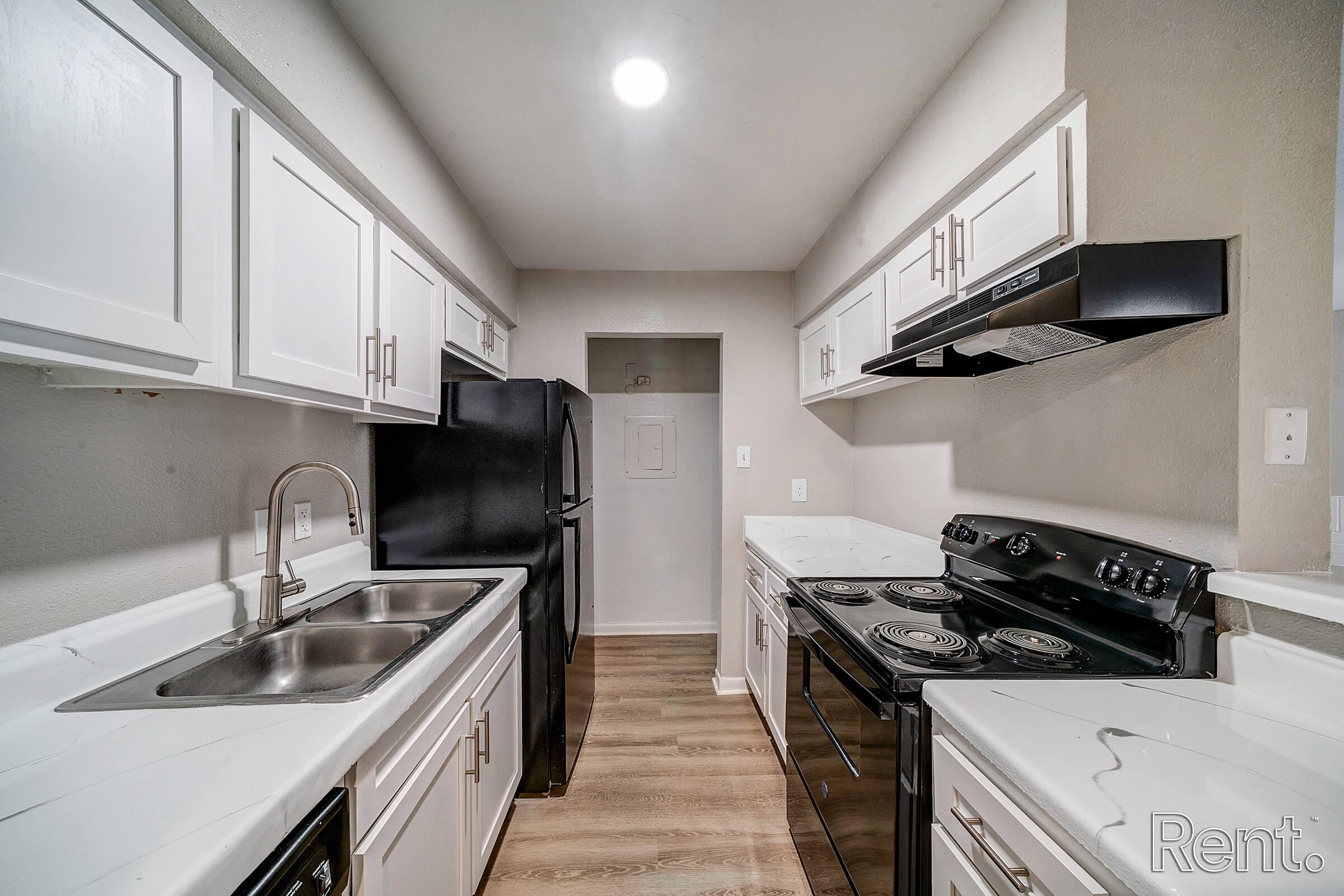 a kitchen with a stove and a sink