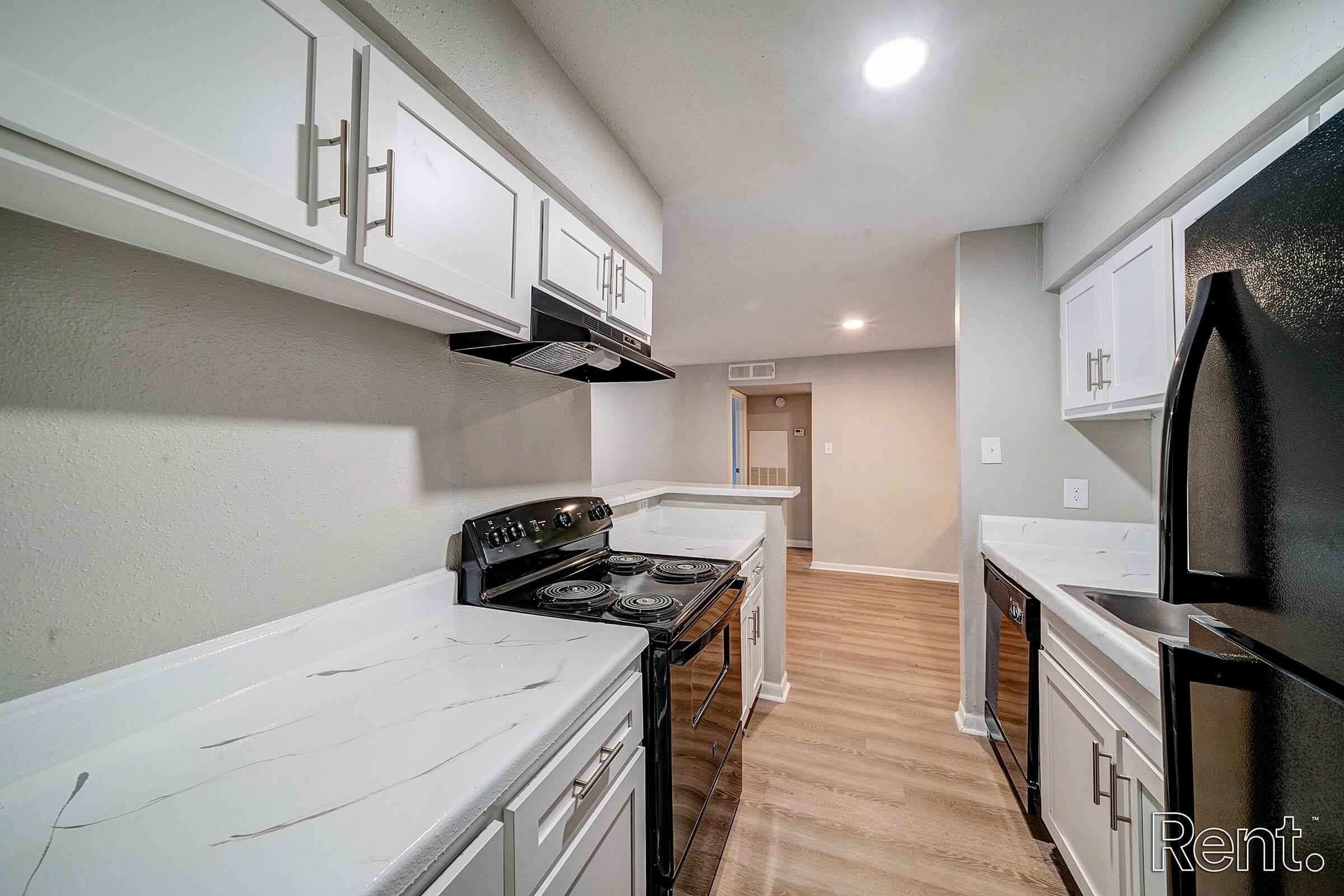 a kitchen with a stove sink and refrigerator