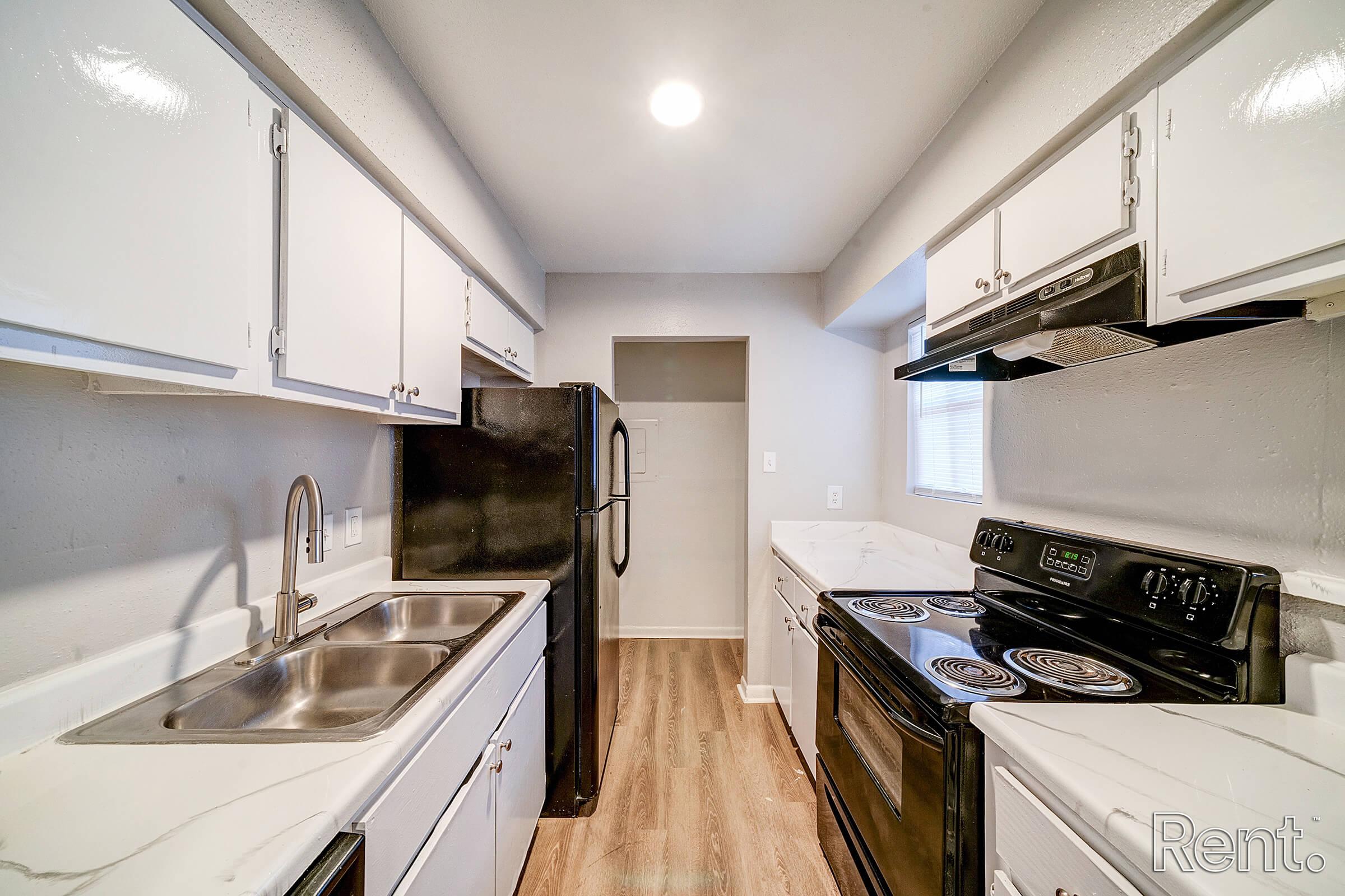 a kitchen with a stove and a sink