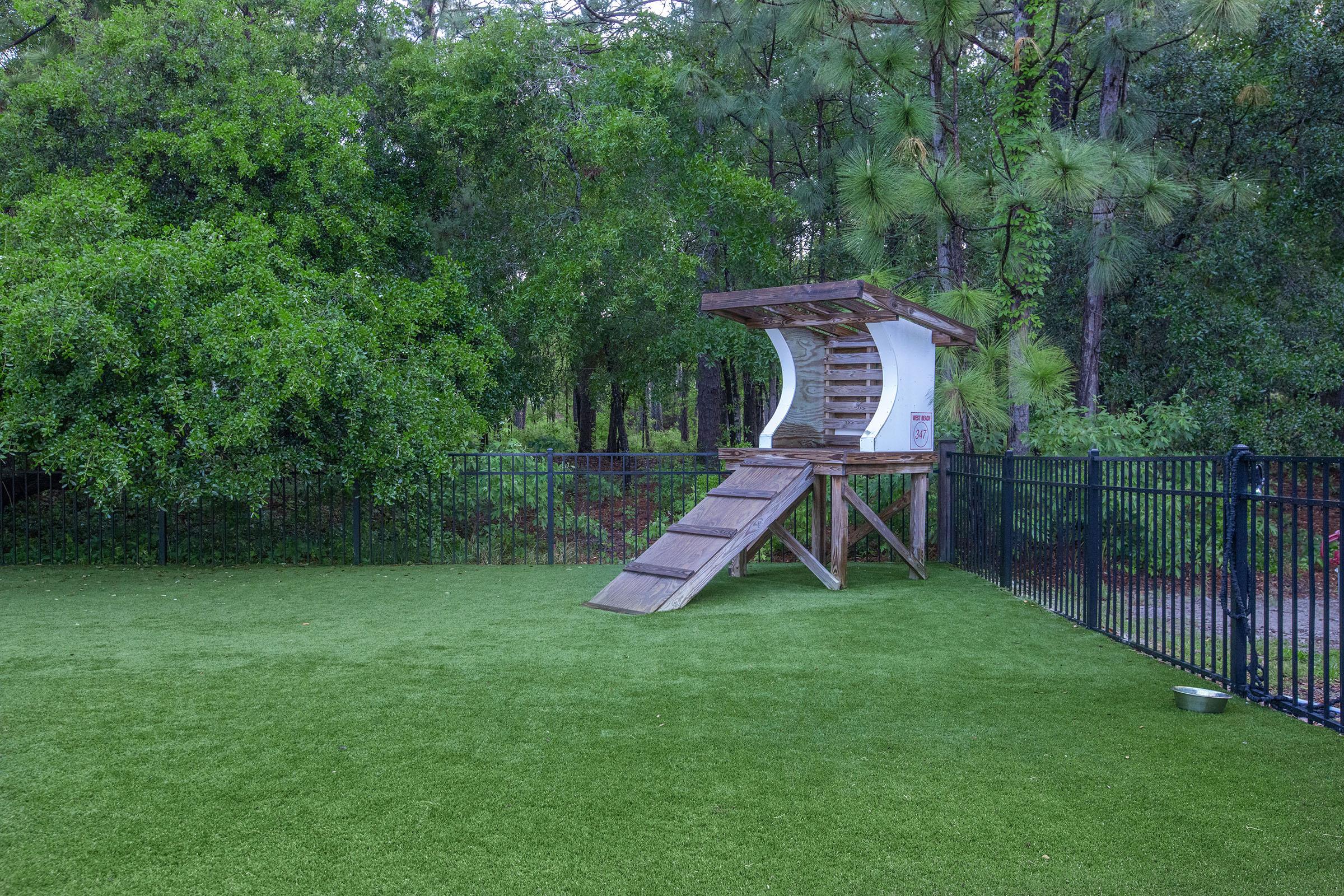 a couple of lawn chairs sitting on top of a lush green field