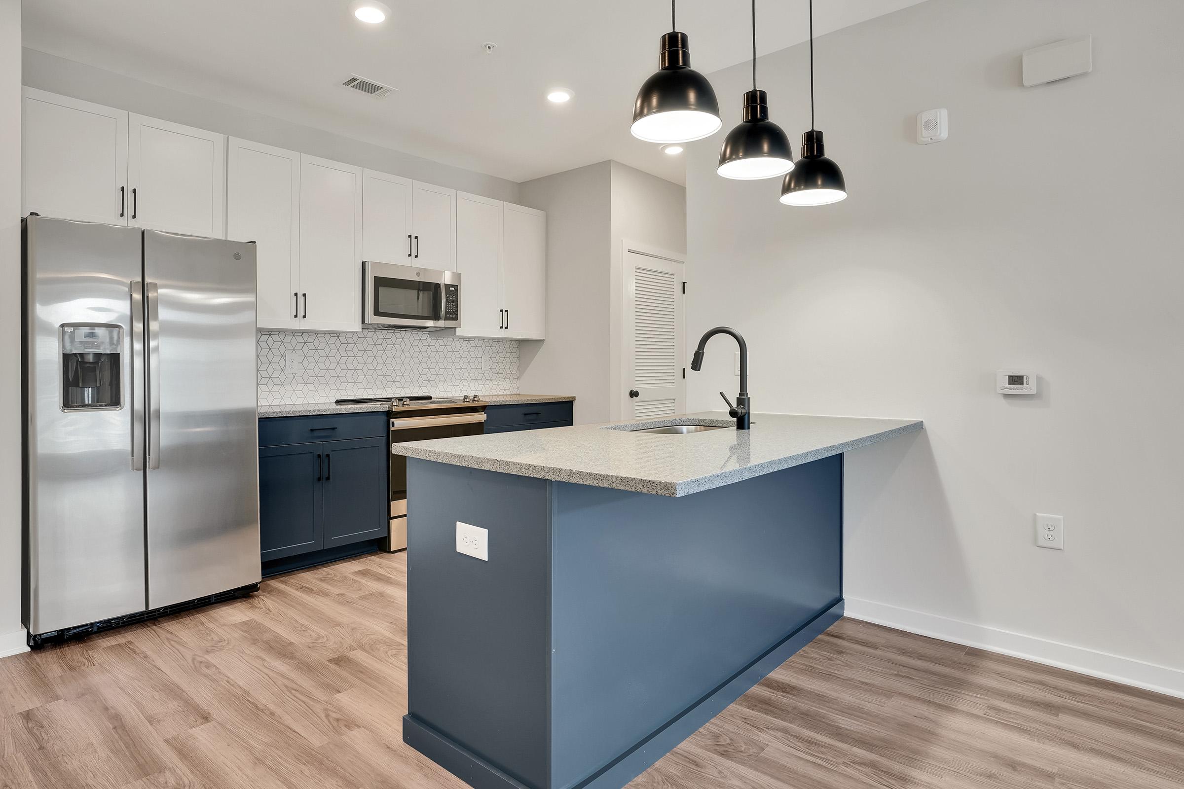 a kitchen with a sink and a refrigerator