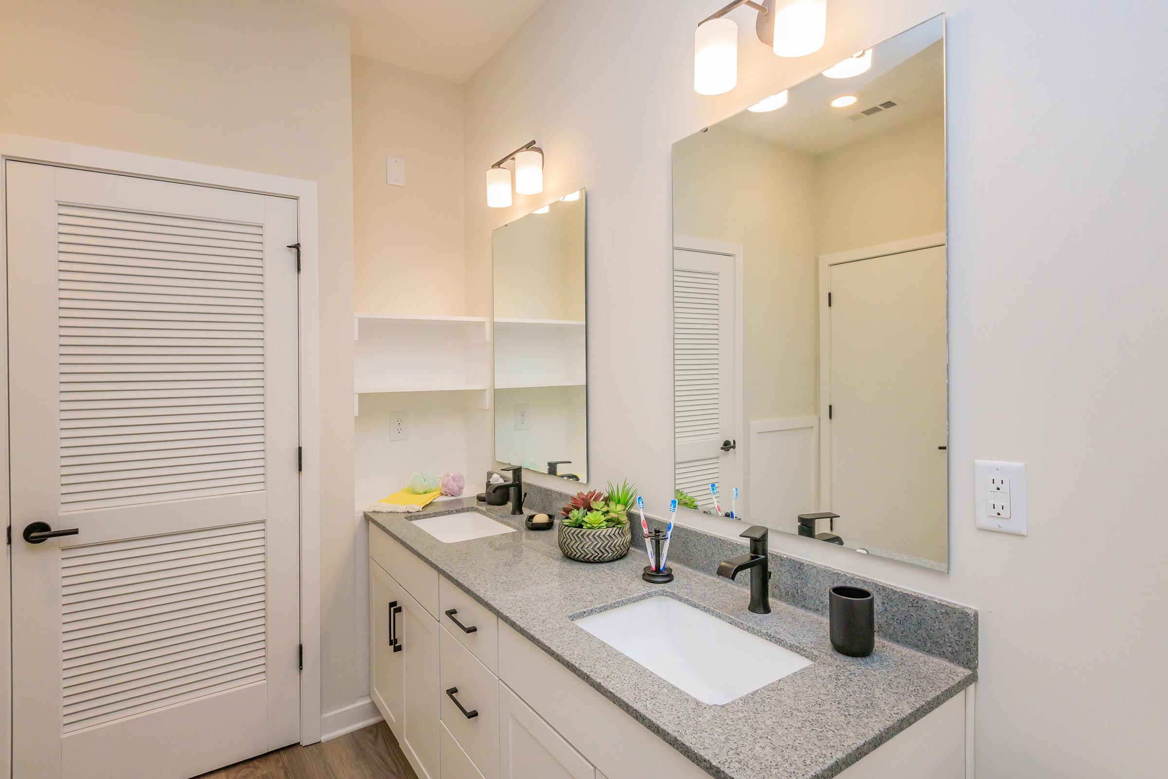 a kitchen with a sink and a mirror