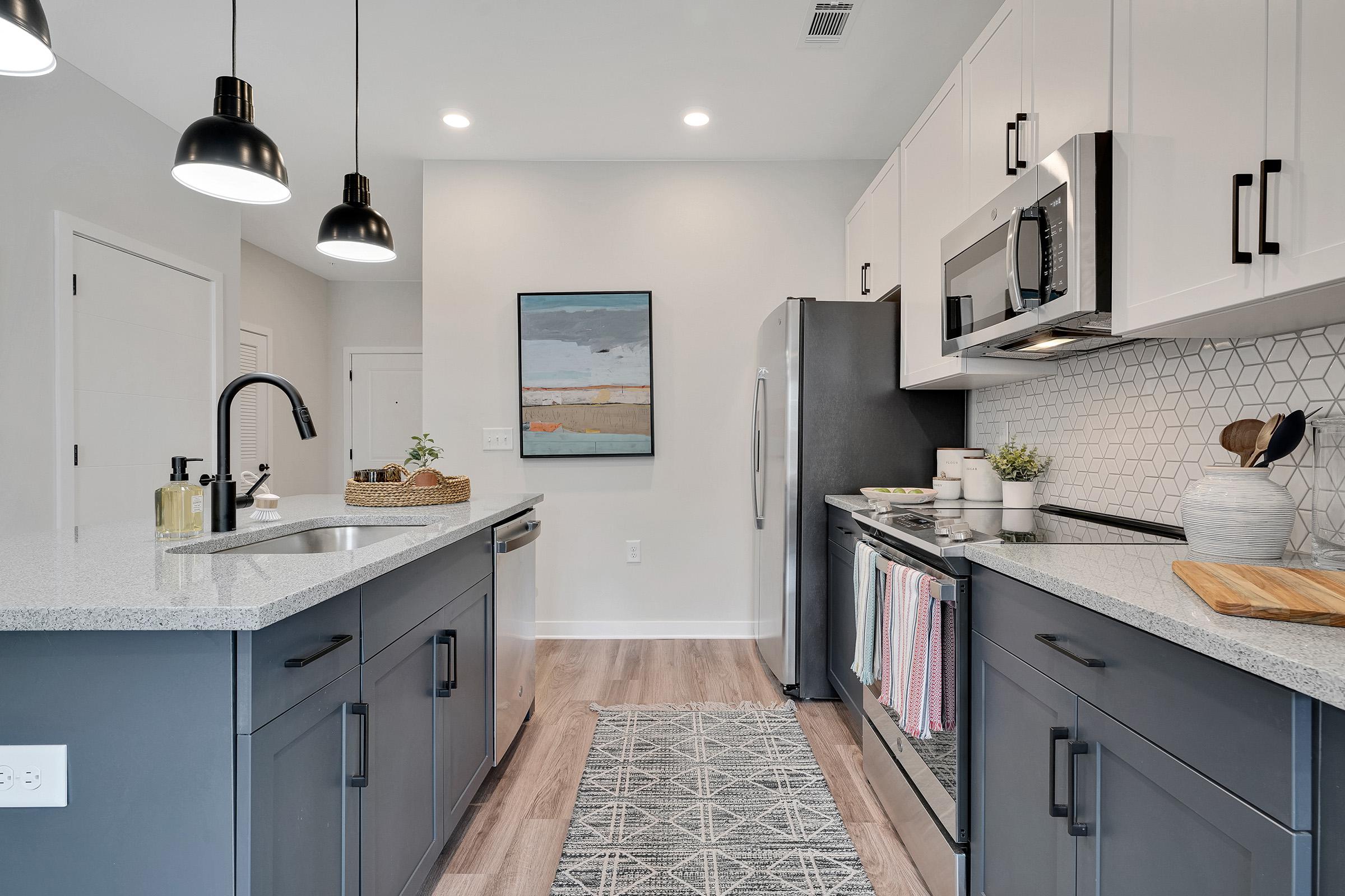 a kitchen with a sink and a mirror