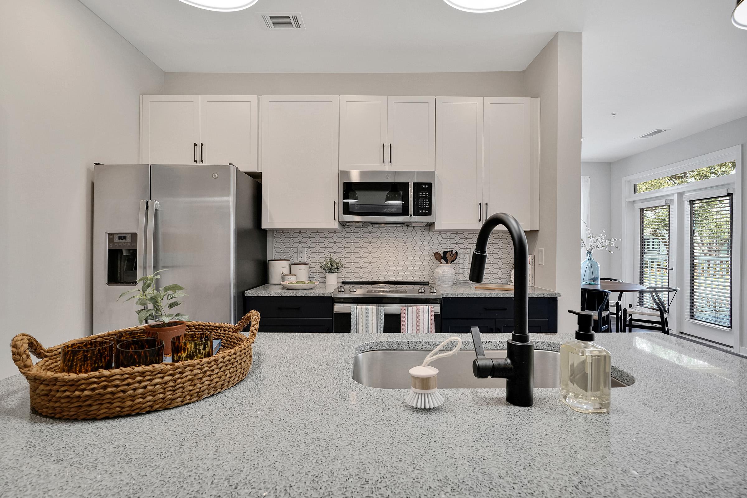 a kitchen with a sink and a mirror