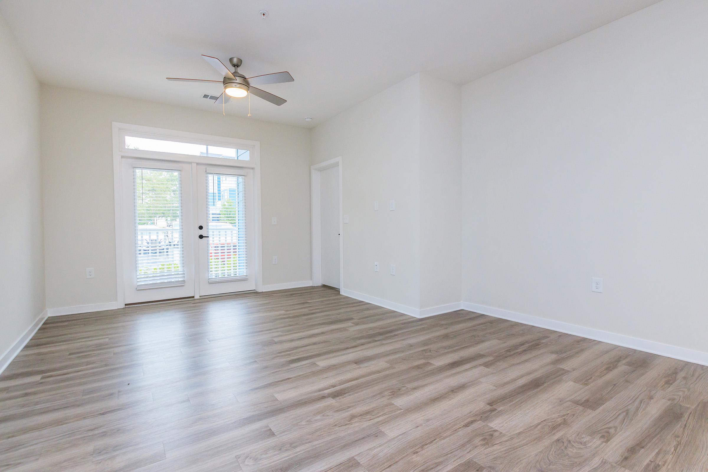 a large empty room with a wooden floor