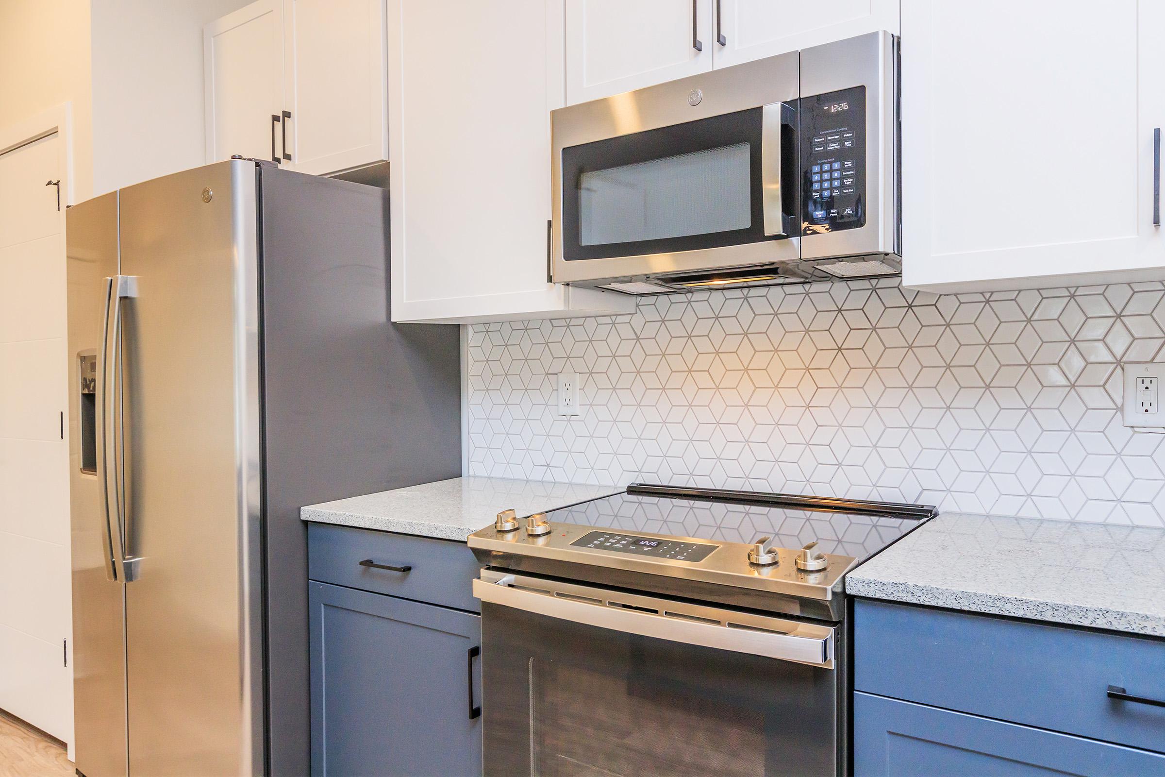 a stove top oven sitting inside of a kitchen