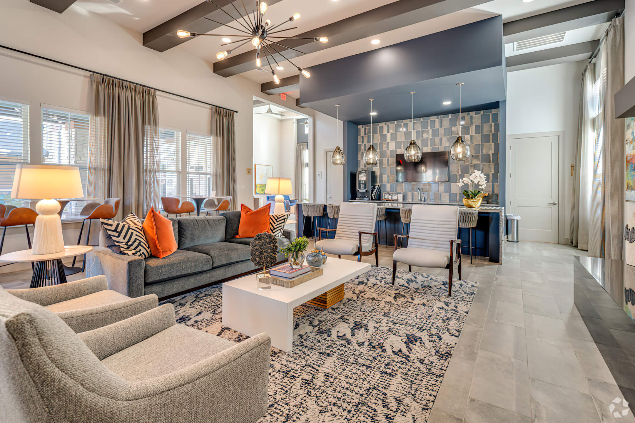 a living room filled with furniture and a large window