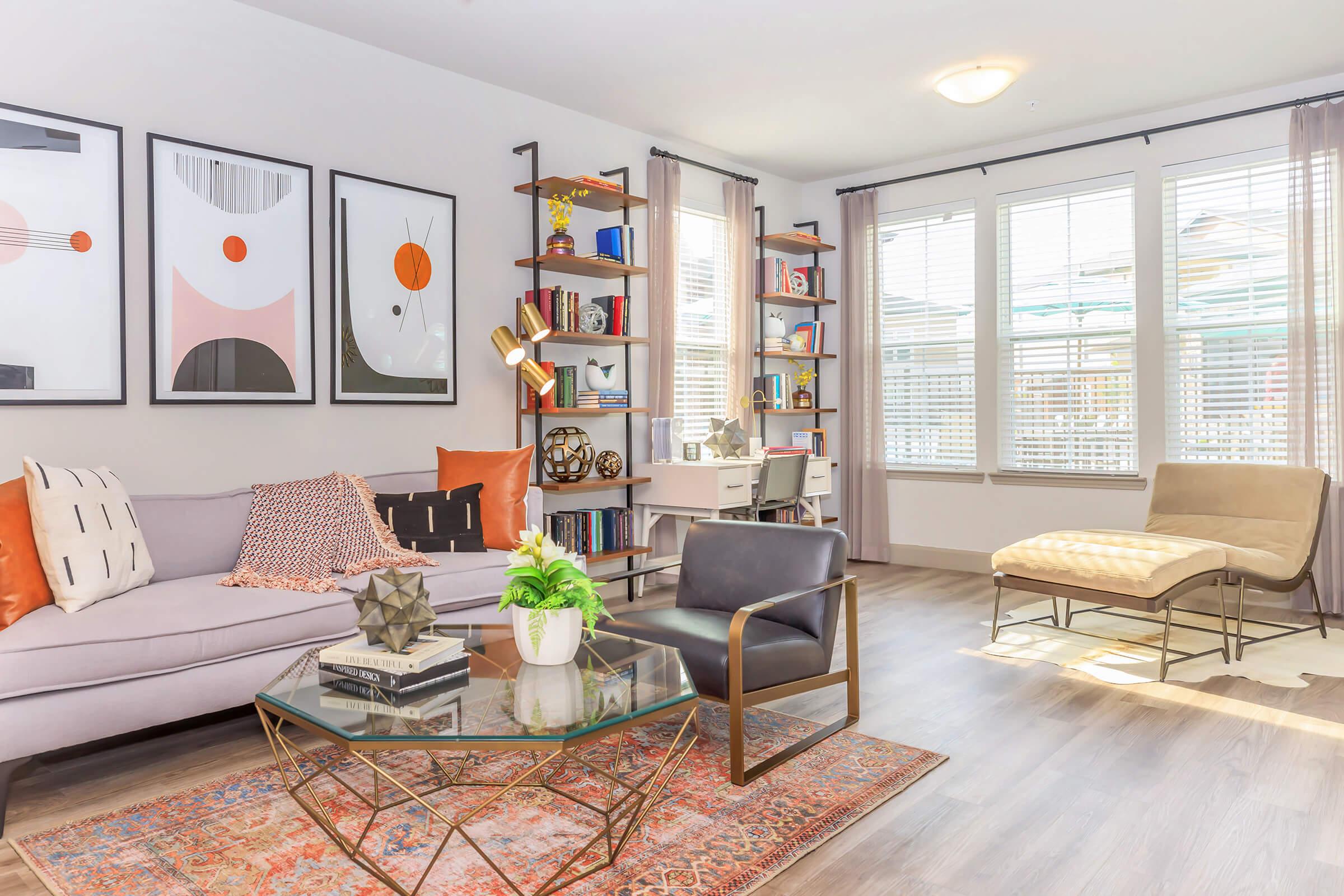 a living room filled with furniture and a large window