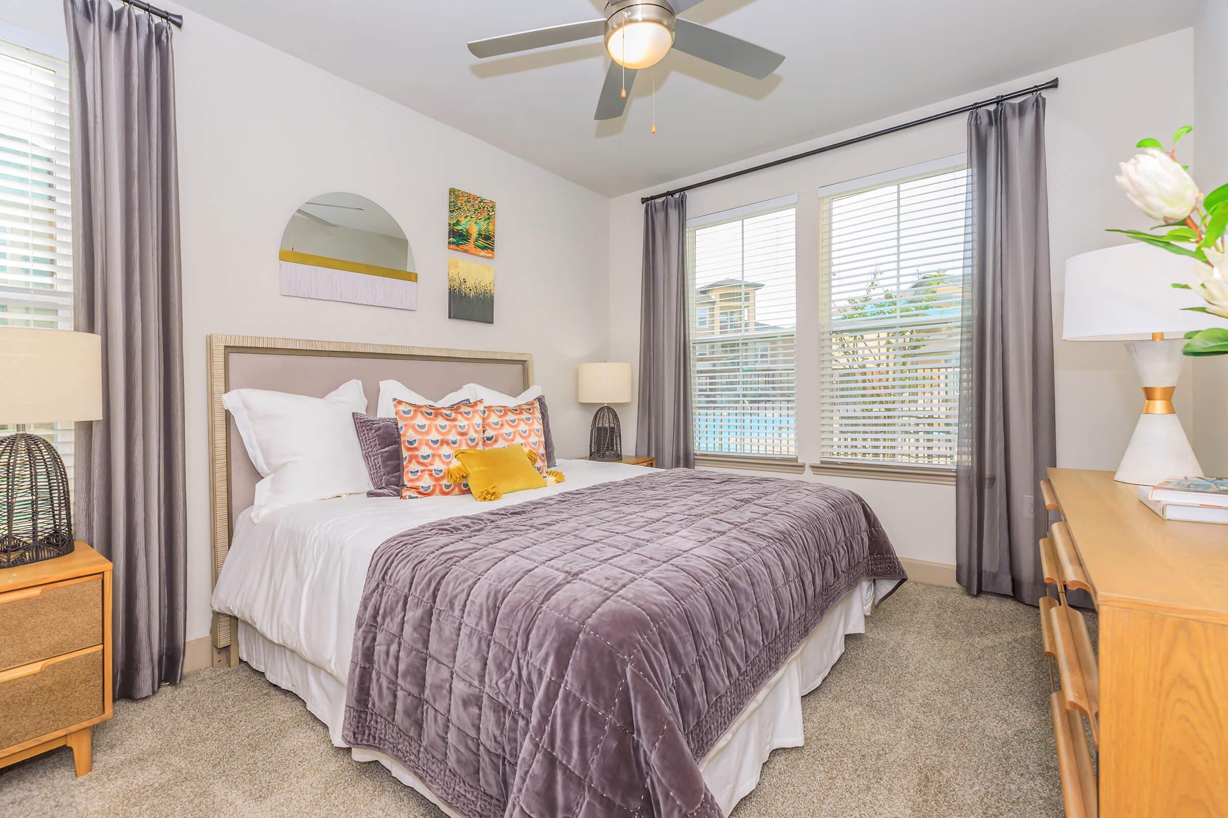 a bedroom with a bed and desk in a room