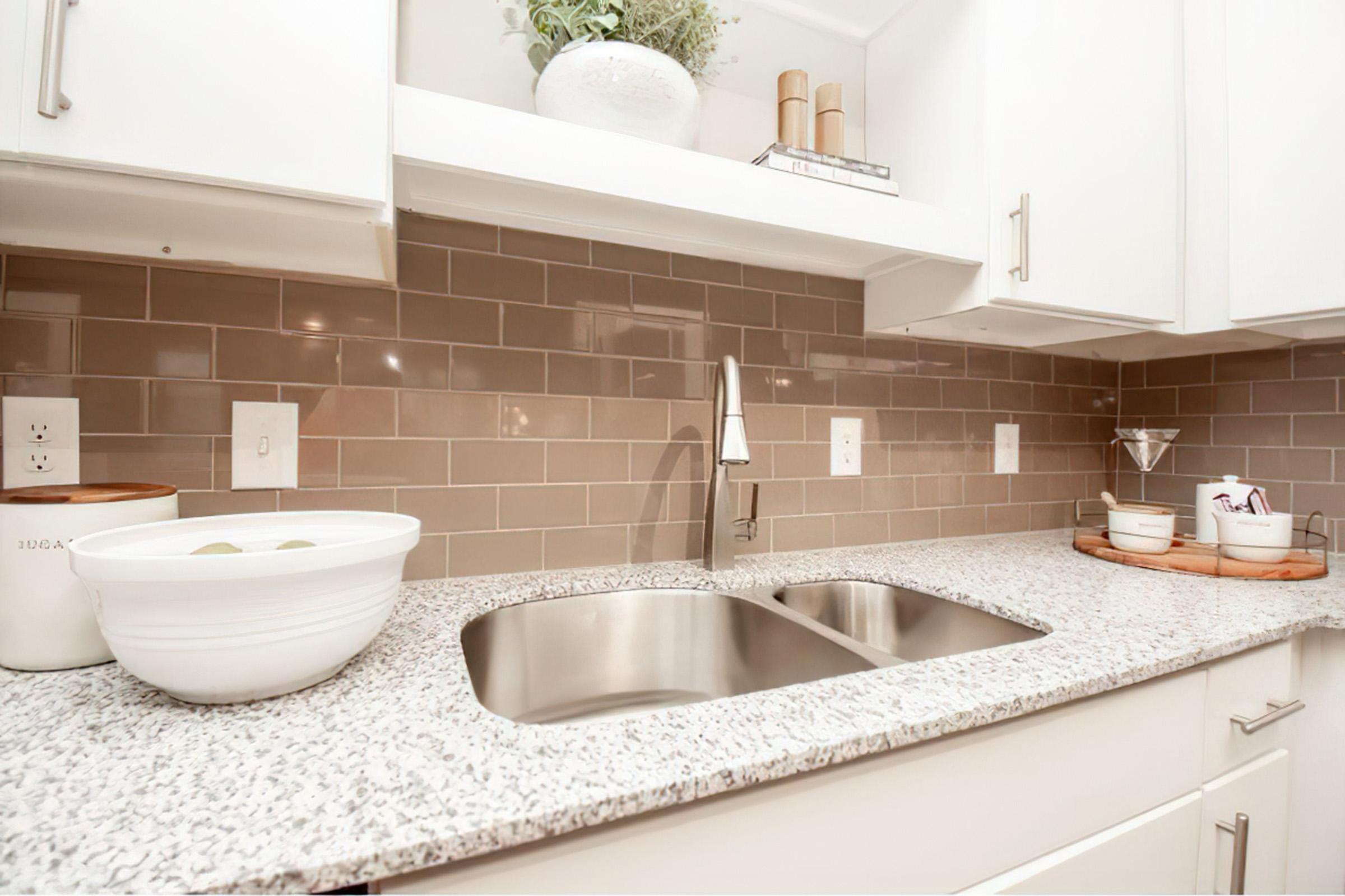 a kitchen with a sink and a mirror