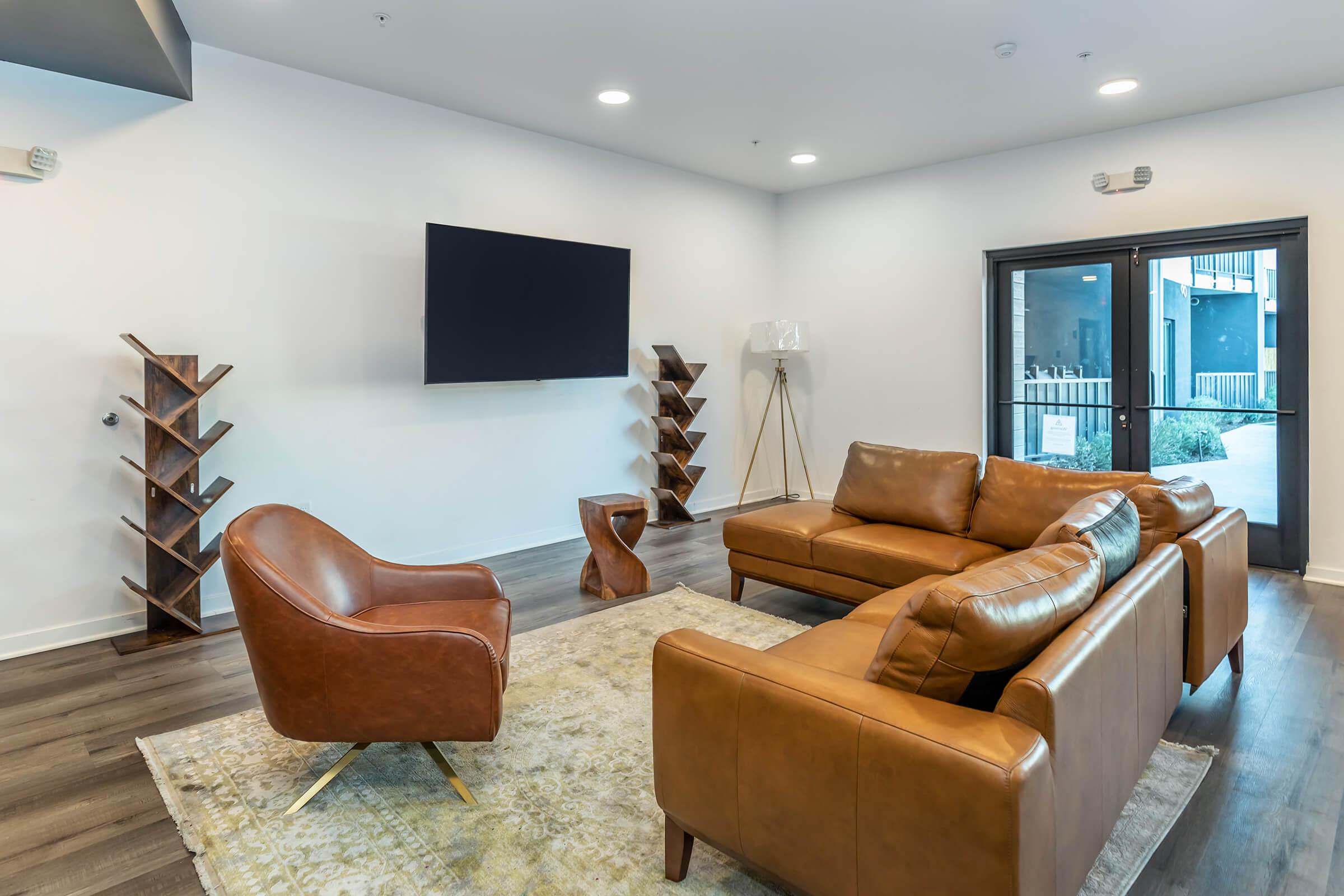 a living room filled with furniture and a flat screen tv