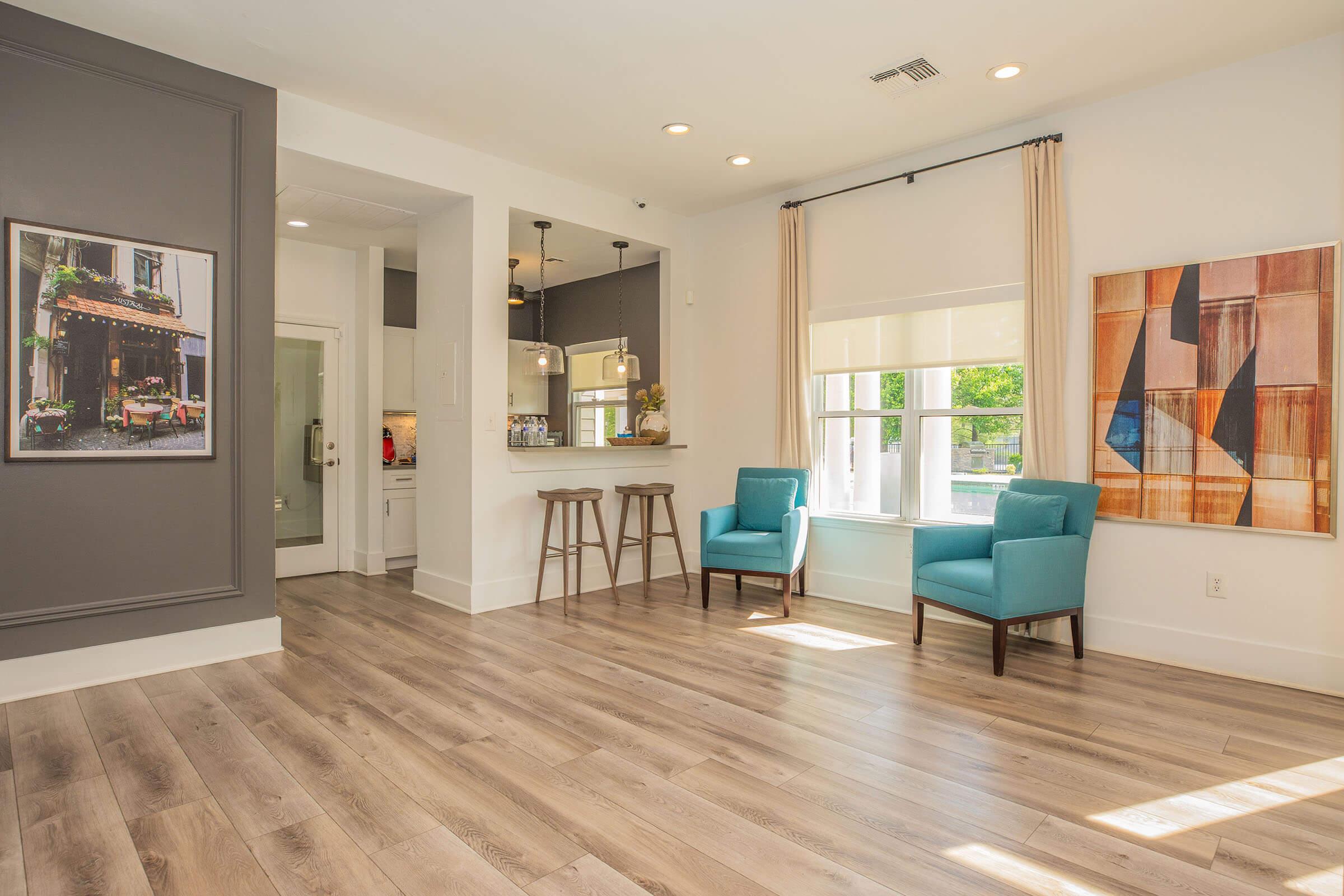 a living room filled with furniture and a large window