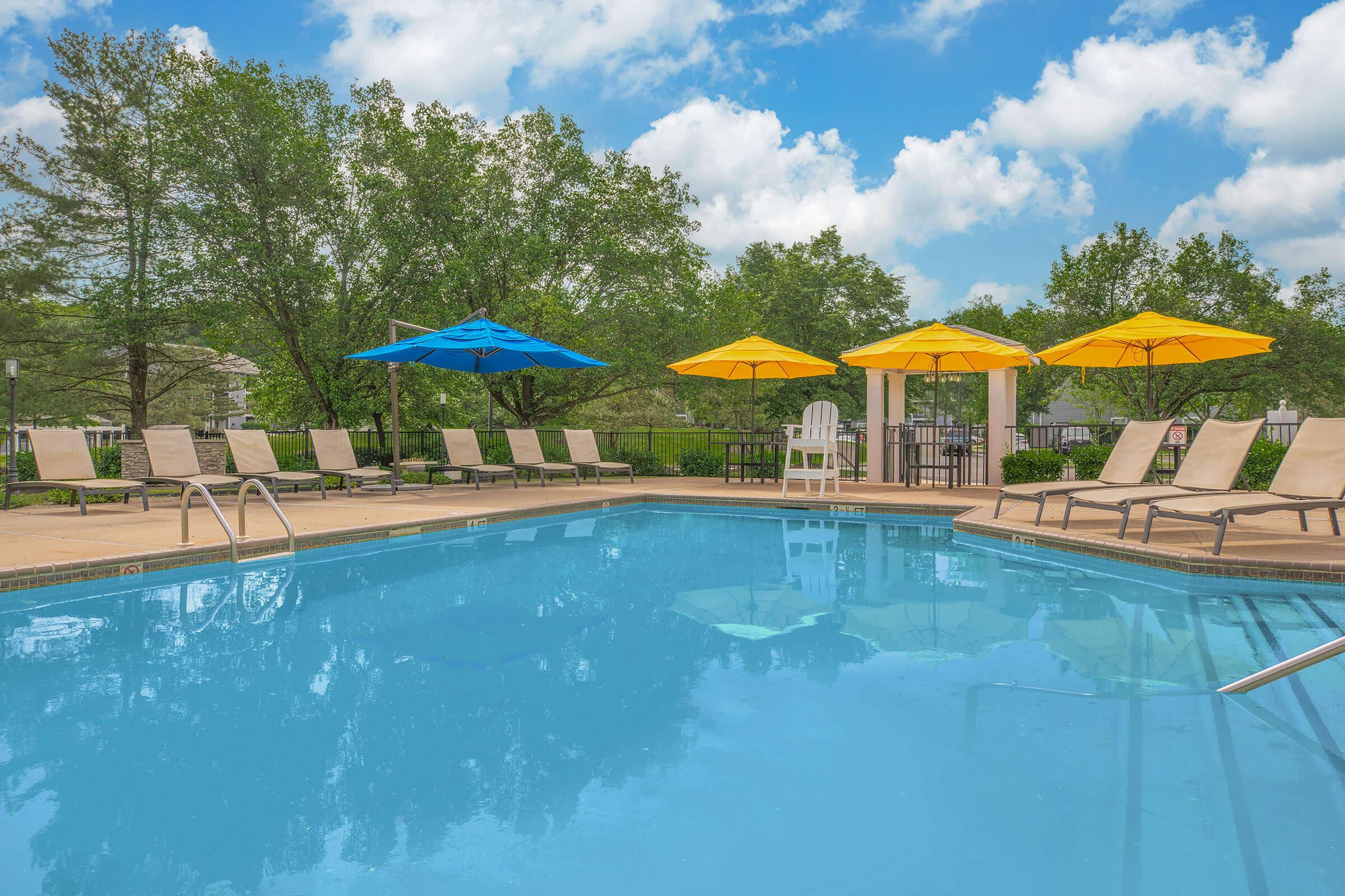 a blue umbrella next to a pool of water