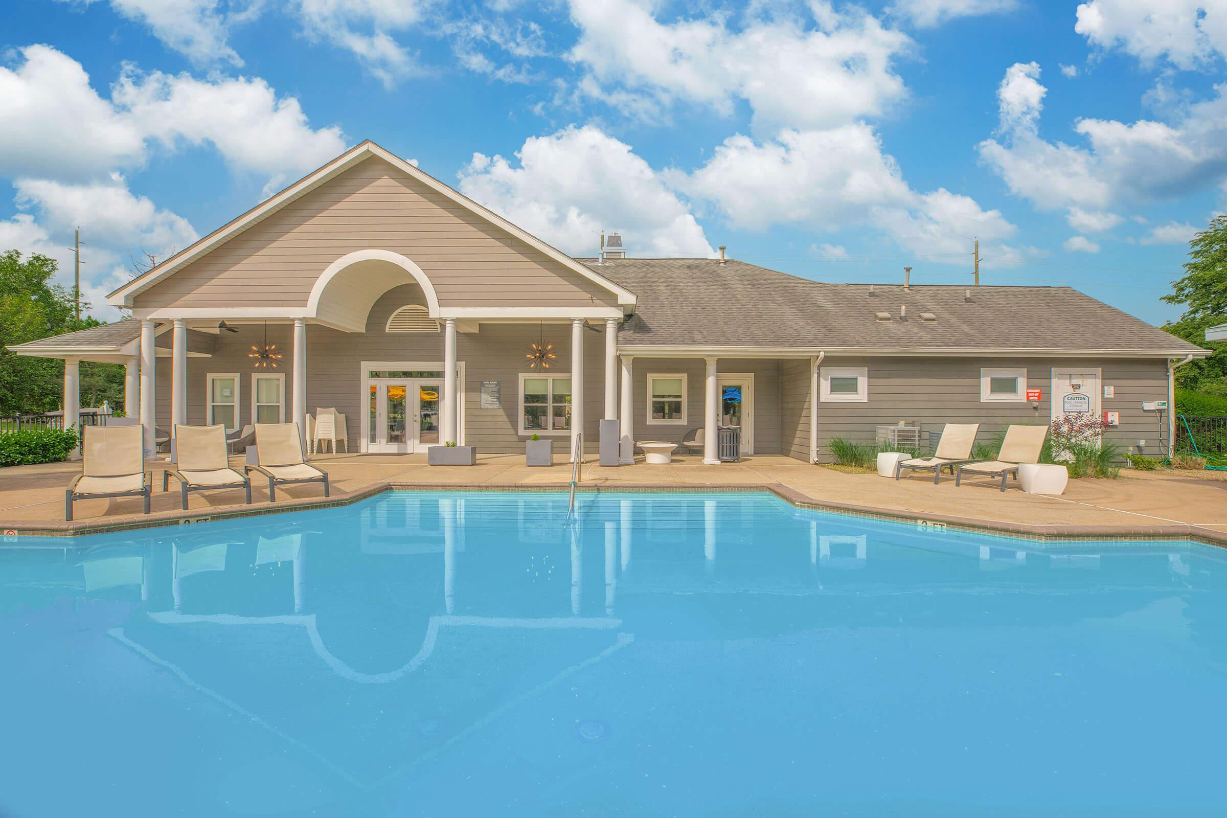 a house with a pool in front of a building