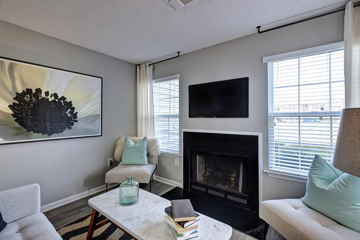 a living room filled with furniture and a flat screen tv