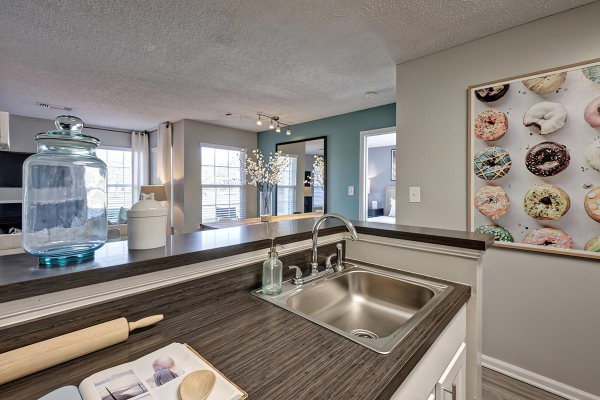 a kitchen with a sink and a mirror