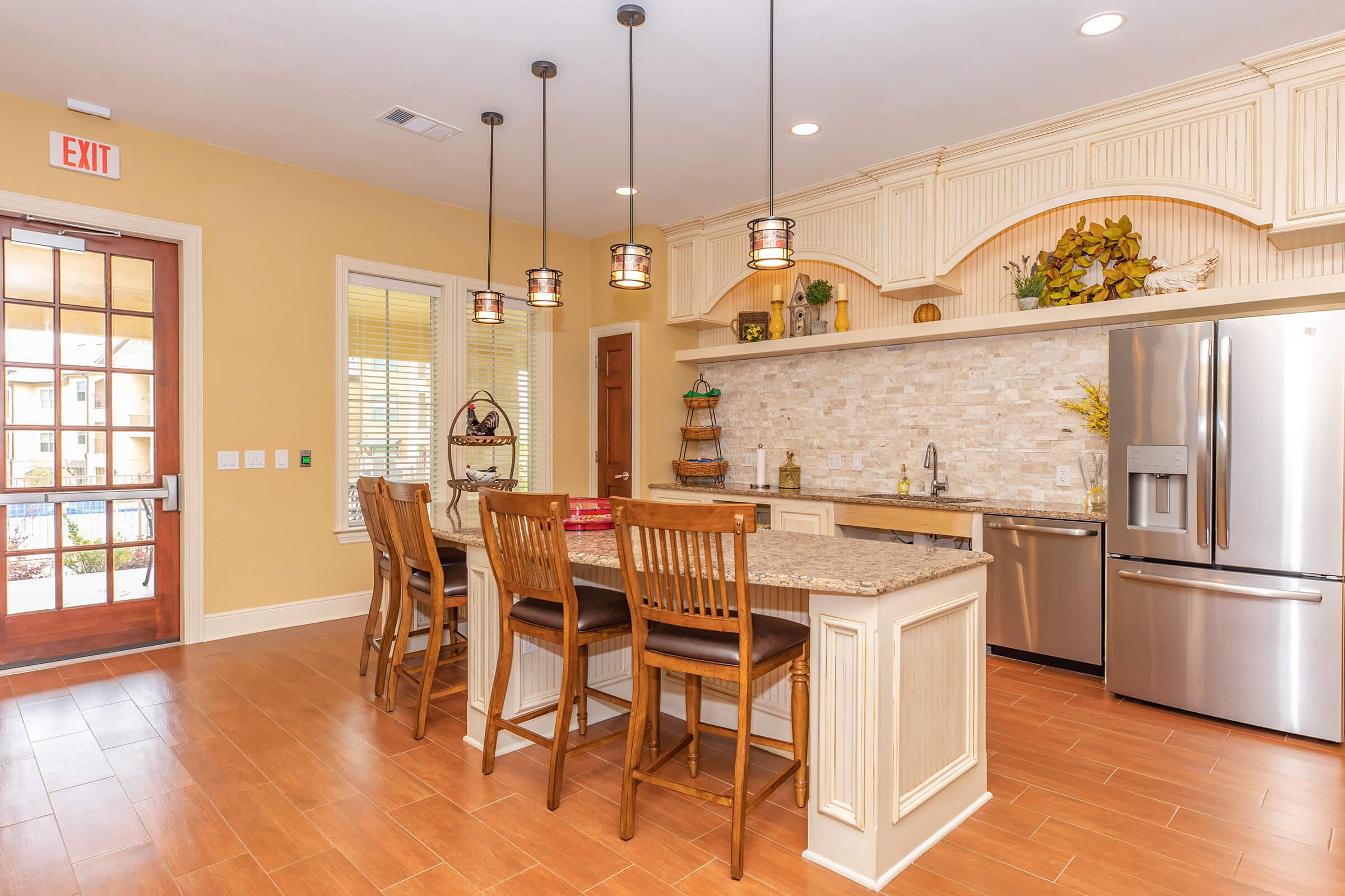 a kitchen with wooden cabinets and a dining room table