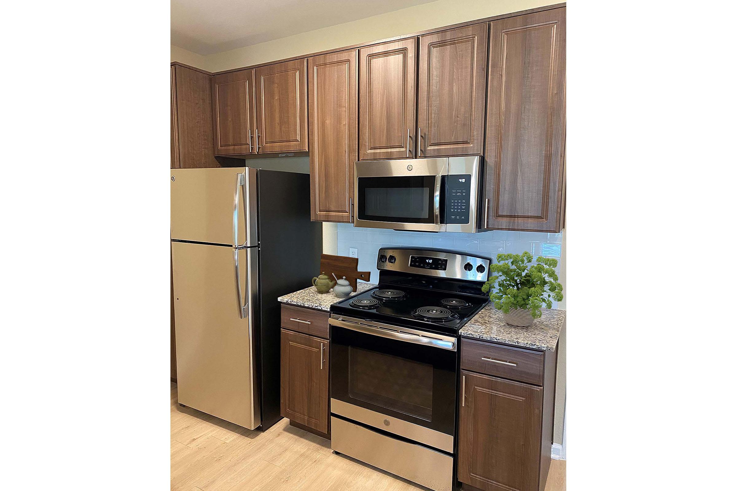 a kitchen with a stove and a refrigerator