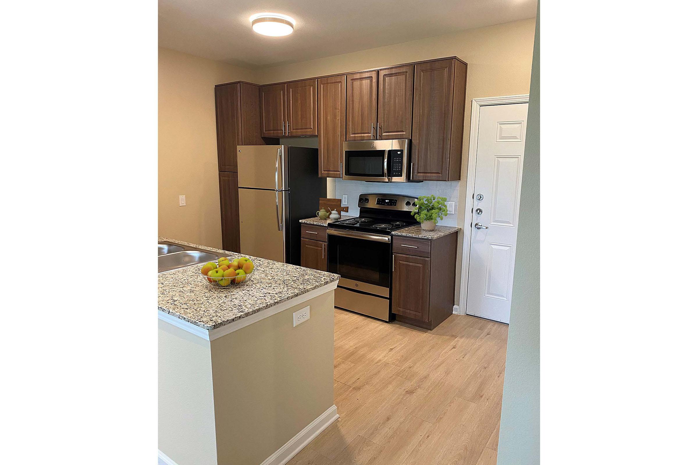 a kitchen with a sink and a refrigerator