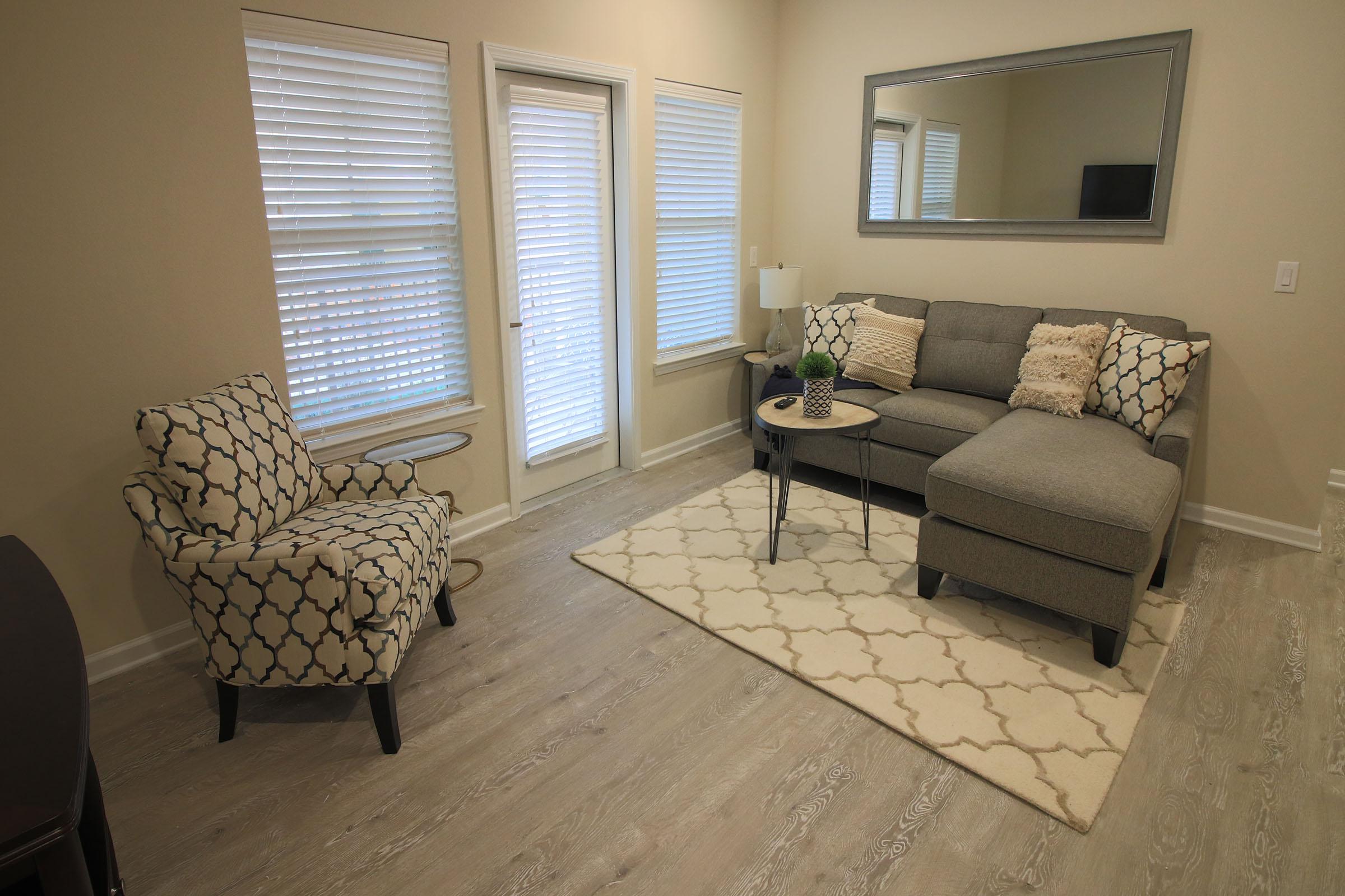 a living room filled with furniture and a large window