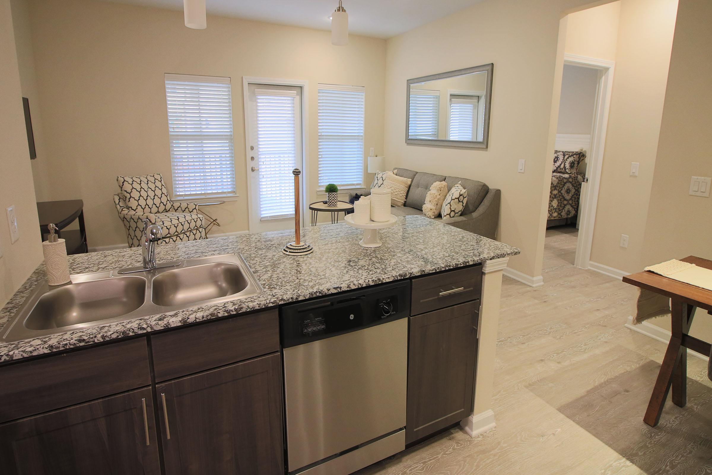 a kitchen with a sink and a mirror