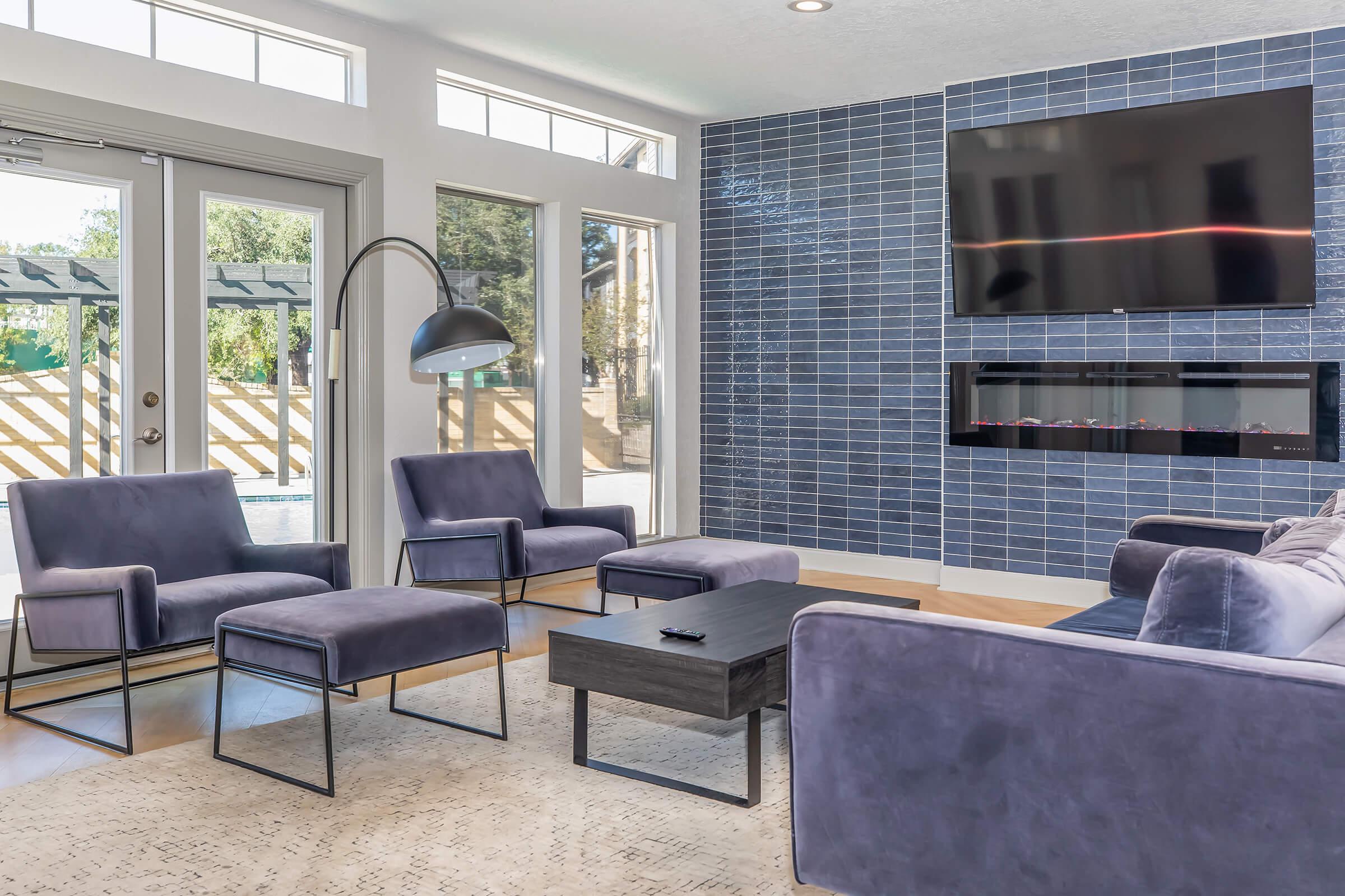 a living room filled with furniture and a large window