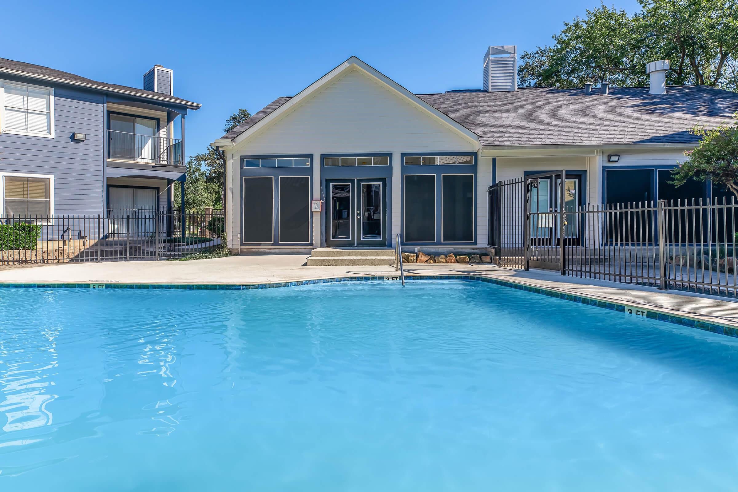 a large pool of water in front of a house