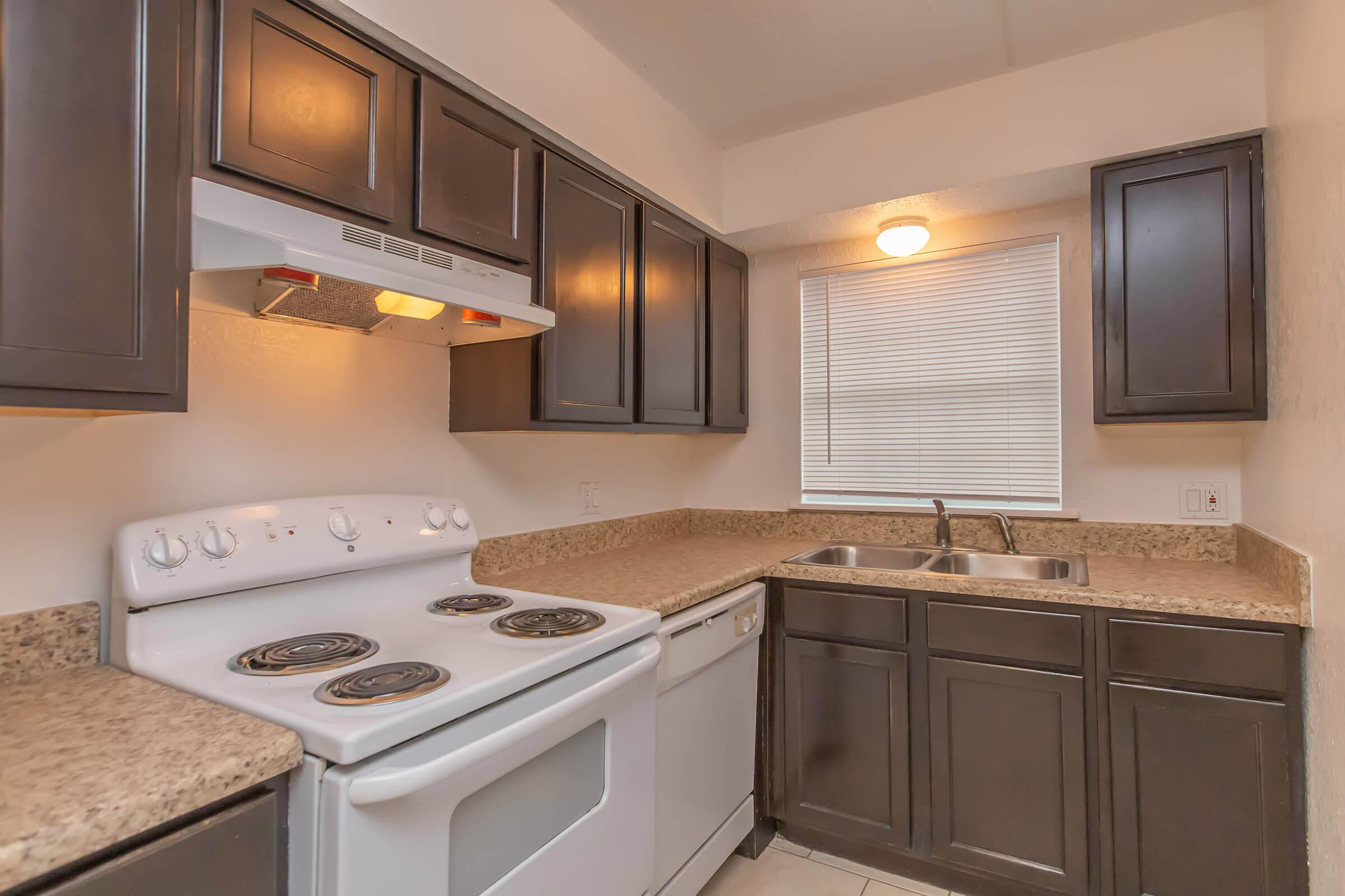 a stove top oven sitting inside of a kitchen