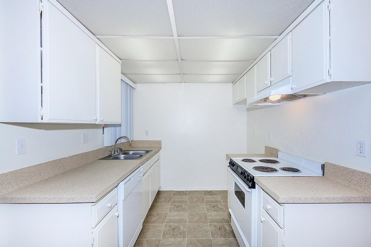 Unfurnished kitchen with white cabinets