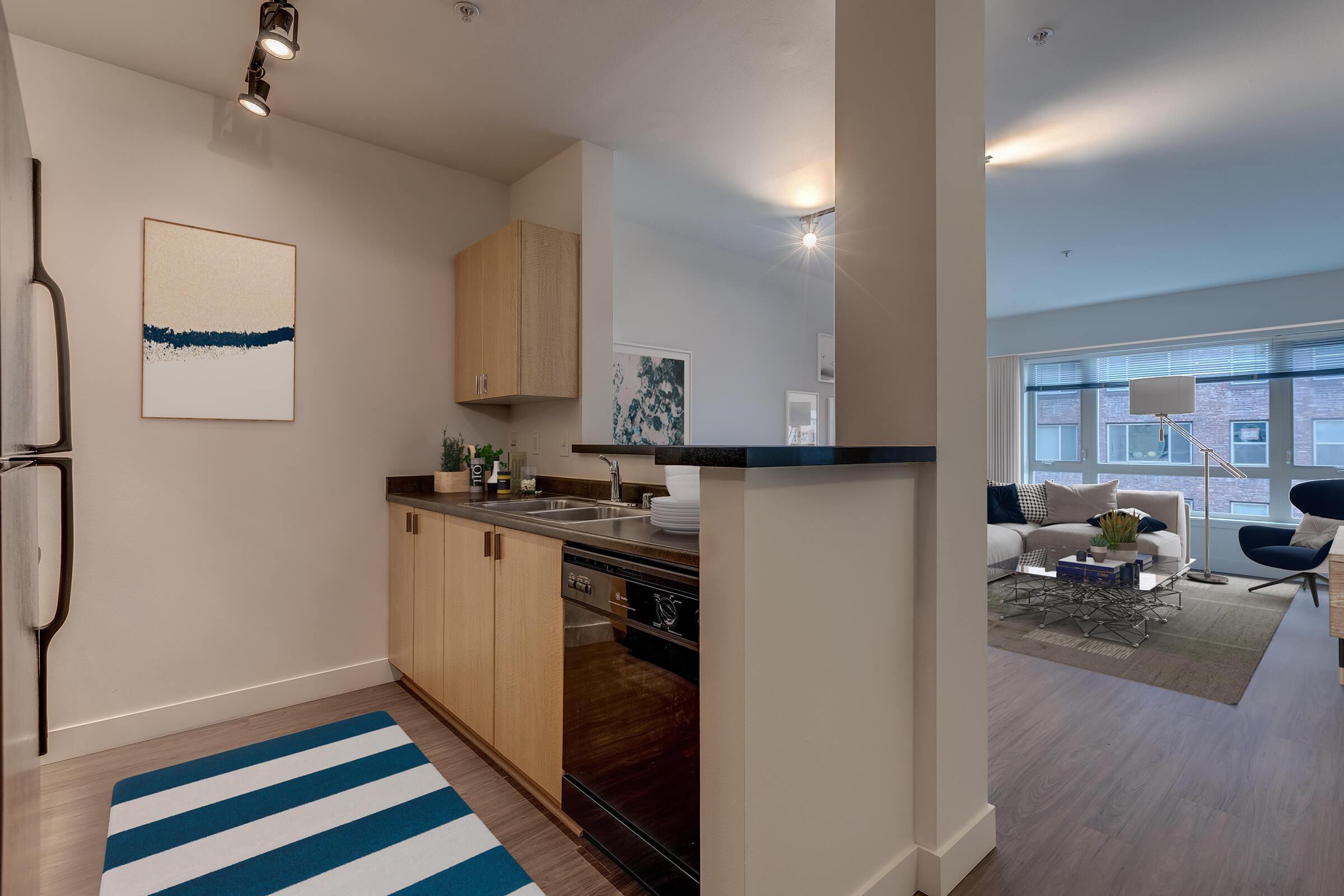 a kitchen with a sink and a mirror in a room