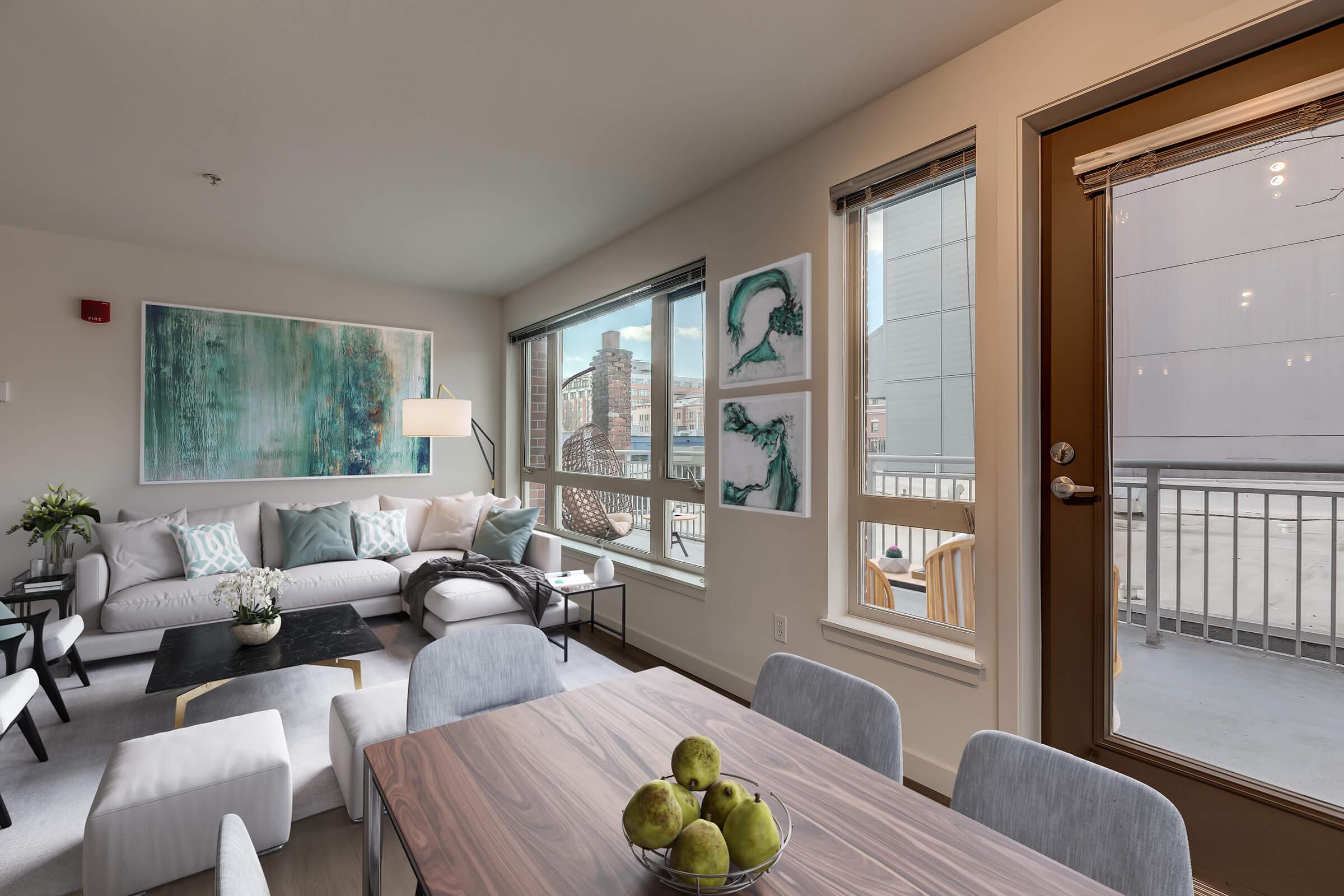 a living room filled with furniture and a large window