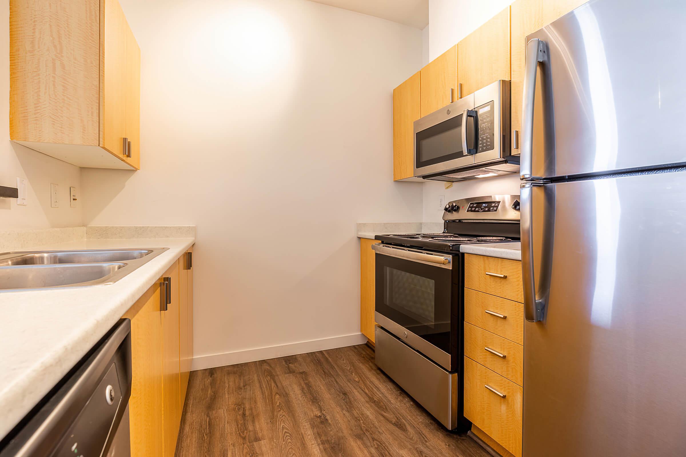 a kitchen with a stove a sink and a microwave