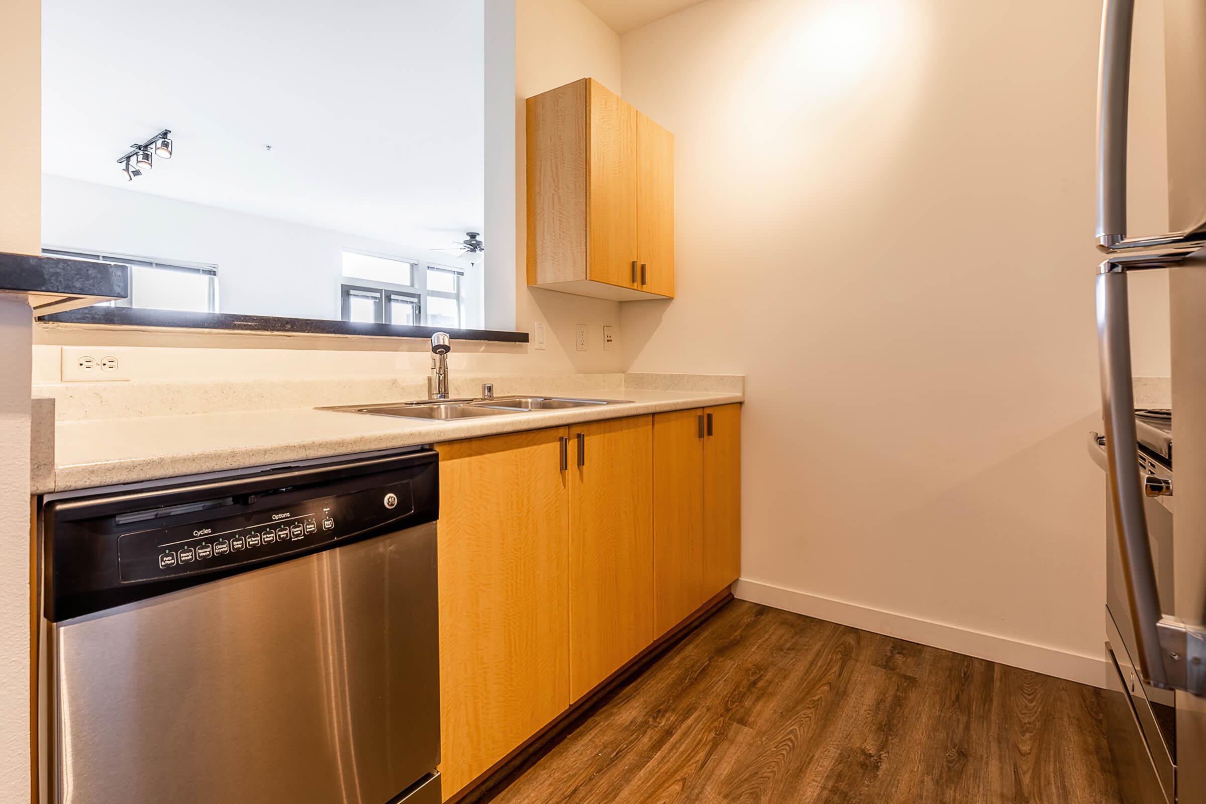 a kitchen with stainless steel appliances and wooden cabinets