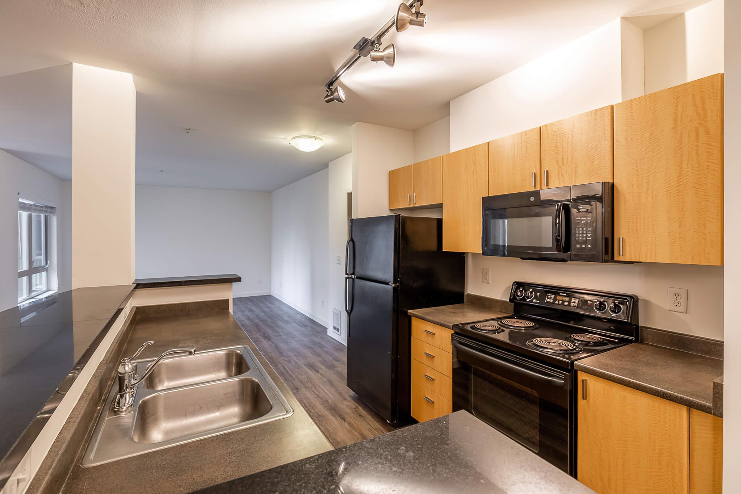 a modern kitchen with stainless steel appliances and wooden cabinets