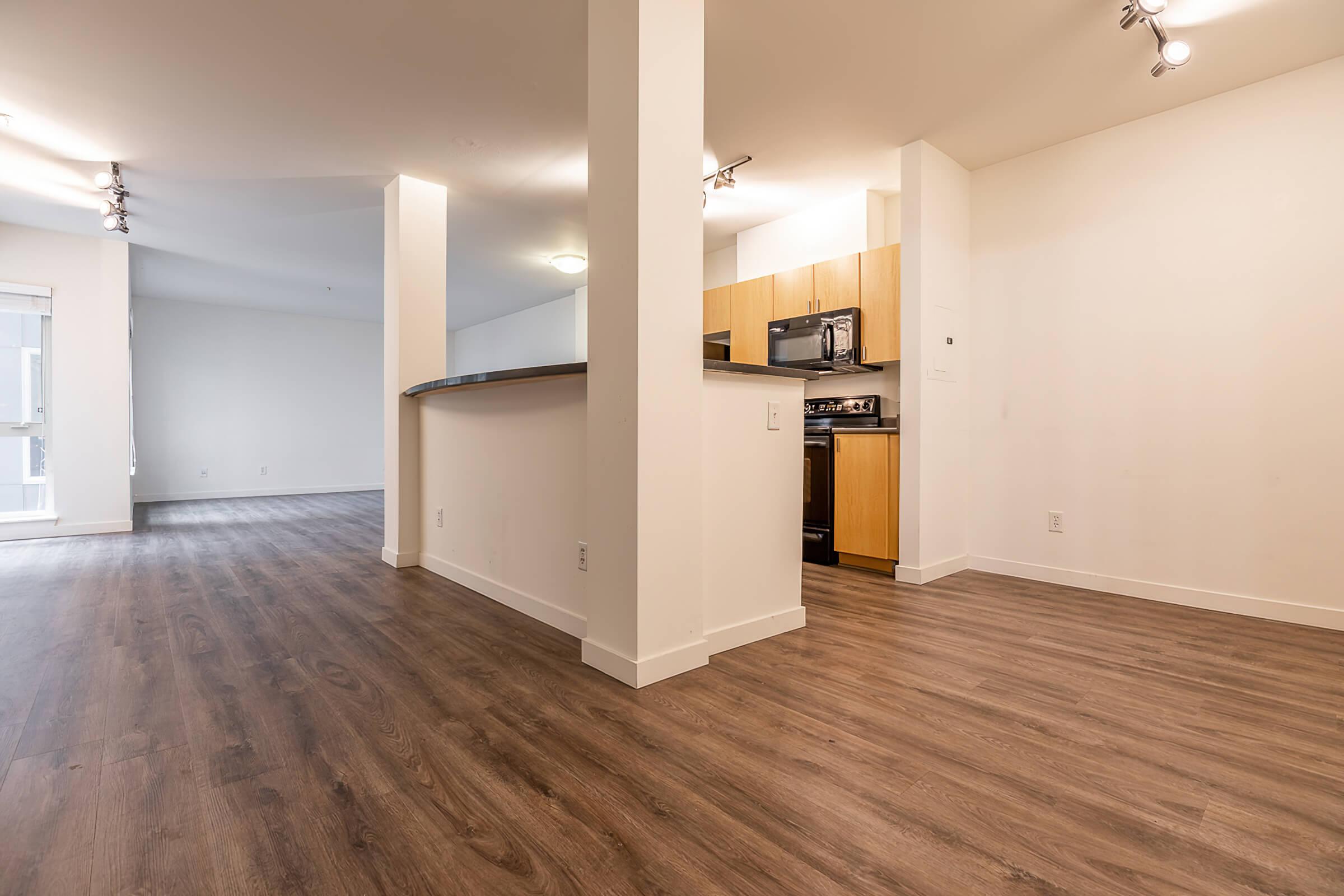 a large empty room with a wood floor