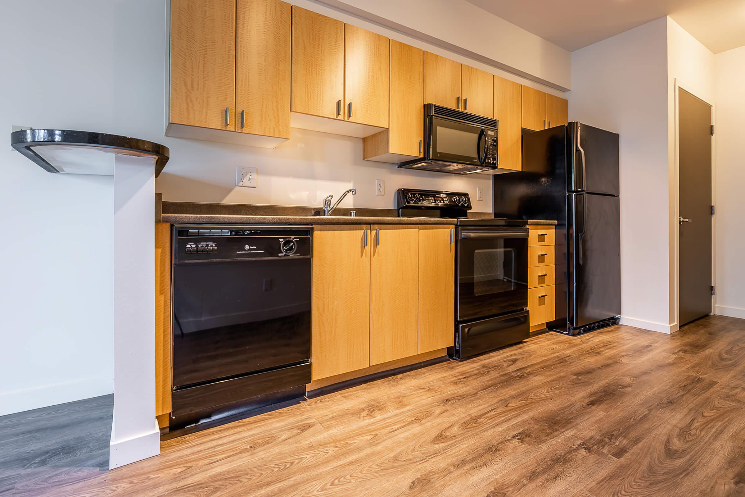 a kitchen with stainless steel appliances and wooden cabinets