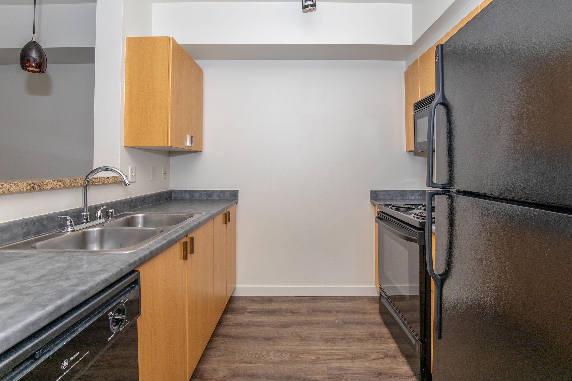 a kitchen with stainless steel appliances and wooden cabinets