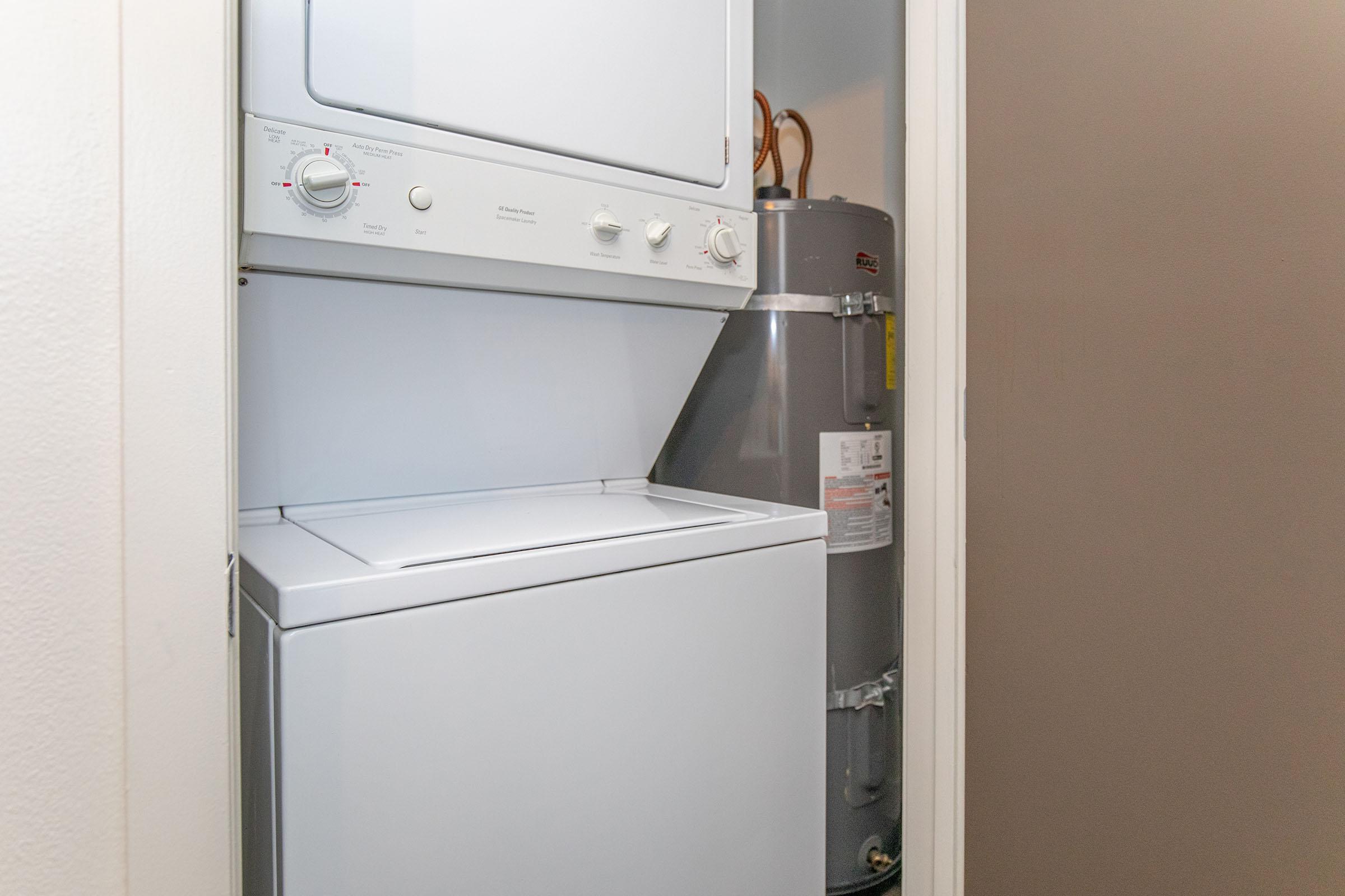 a microwave oven sitting on top of a refrigerator