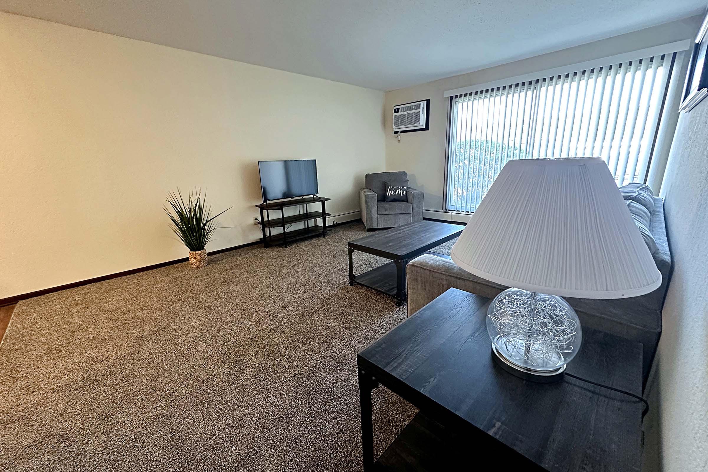 a living room filled with furniture and a large window