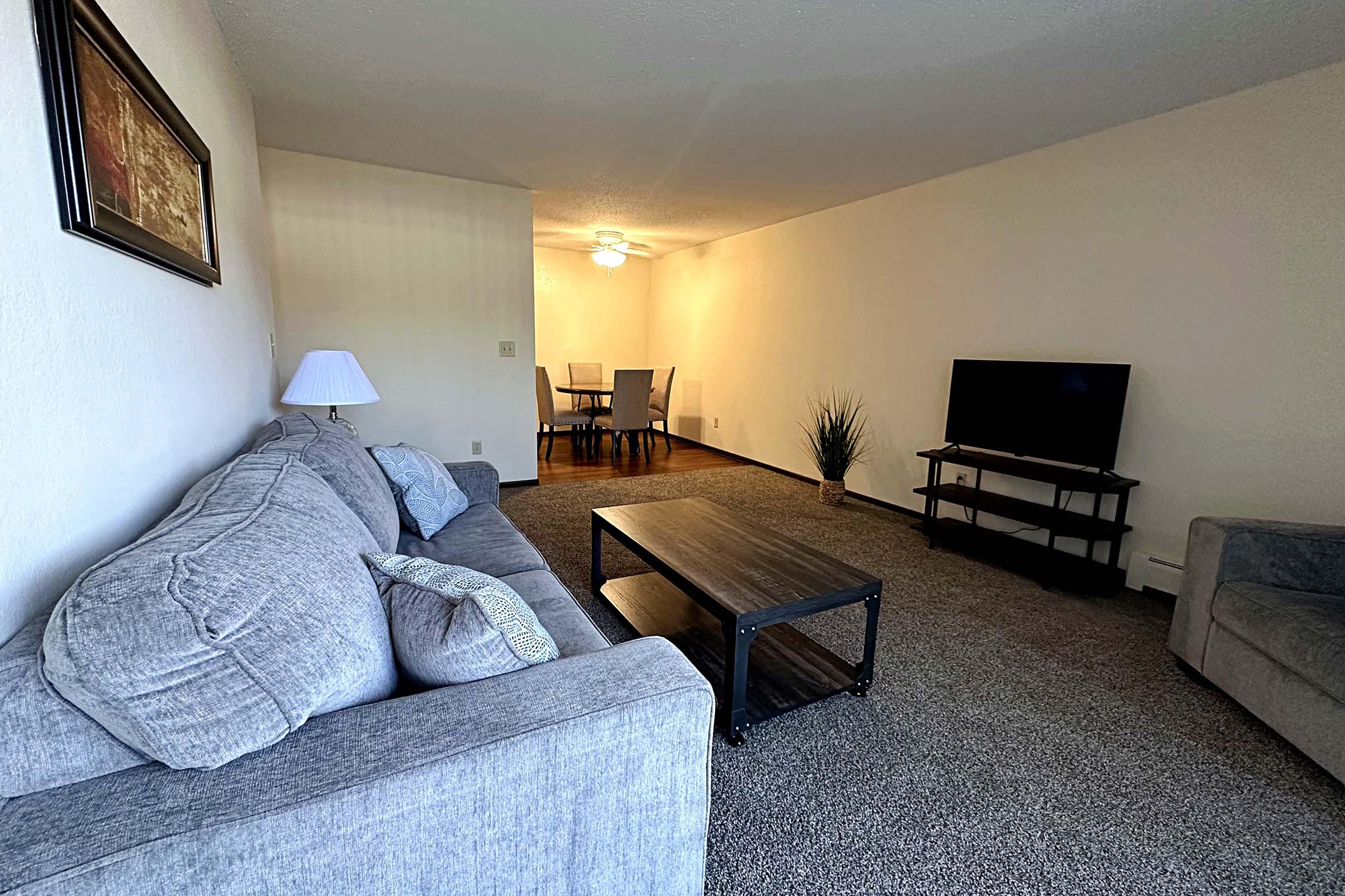 a living room filled with furniture and a bed