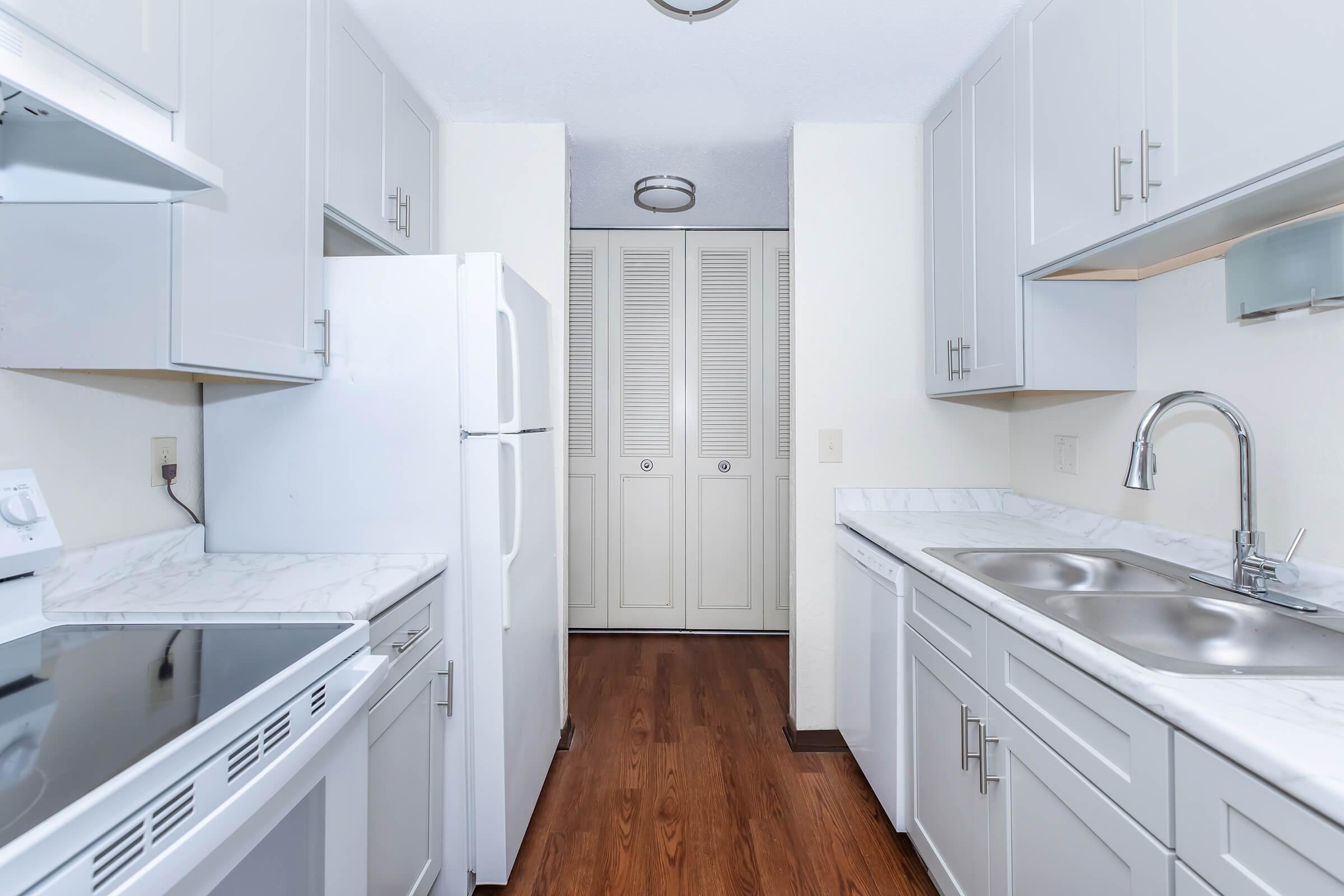 a kitchen with a stove and a sink